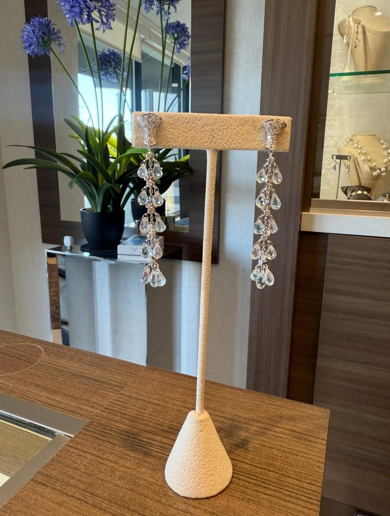 Sue Gragg Aquamarine Diamond Dangle Earrings in 18K White Gold. The earrings features briollete aquamarine beads and brilliant round diamonds. The earrings approximately measure 2.75 inches in length and weigh 10 grams. 