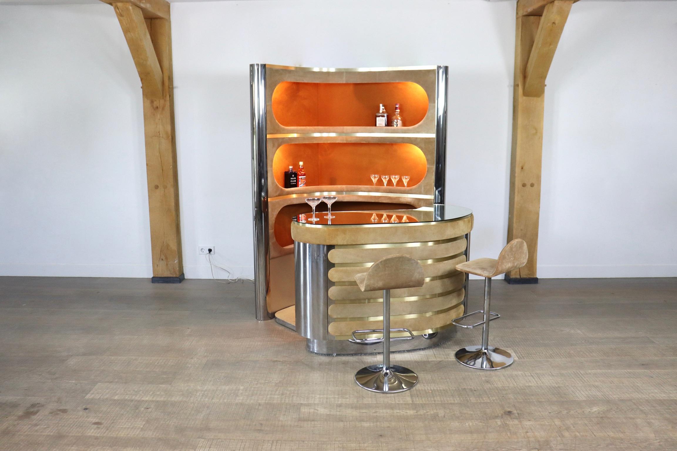 Incredible suede and chrome bar by Willy Rizzo 1970s. With original mirror counter, working lights, original refrigerator and two barstools. With this bar, any room will be elevated to a classy and luxurious space. Pour yourself a cold drink and