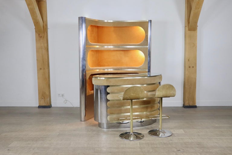 Suede and chrome dry bar with barstools by Willy Rizzo, 1970s.

Incredible suede and chrome bar attributed to Willy Rizzo 1970s. With original mirror counter, working lights, original refrigerator and two barstools. With this bar, any room will be