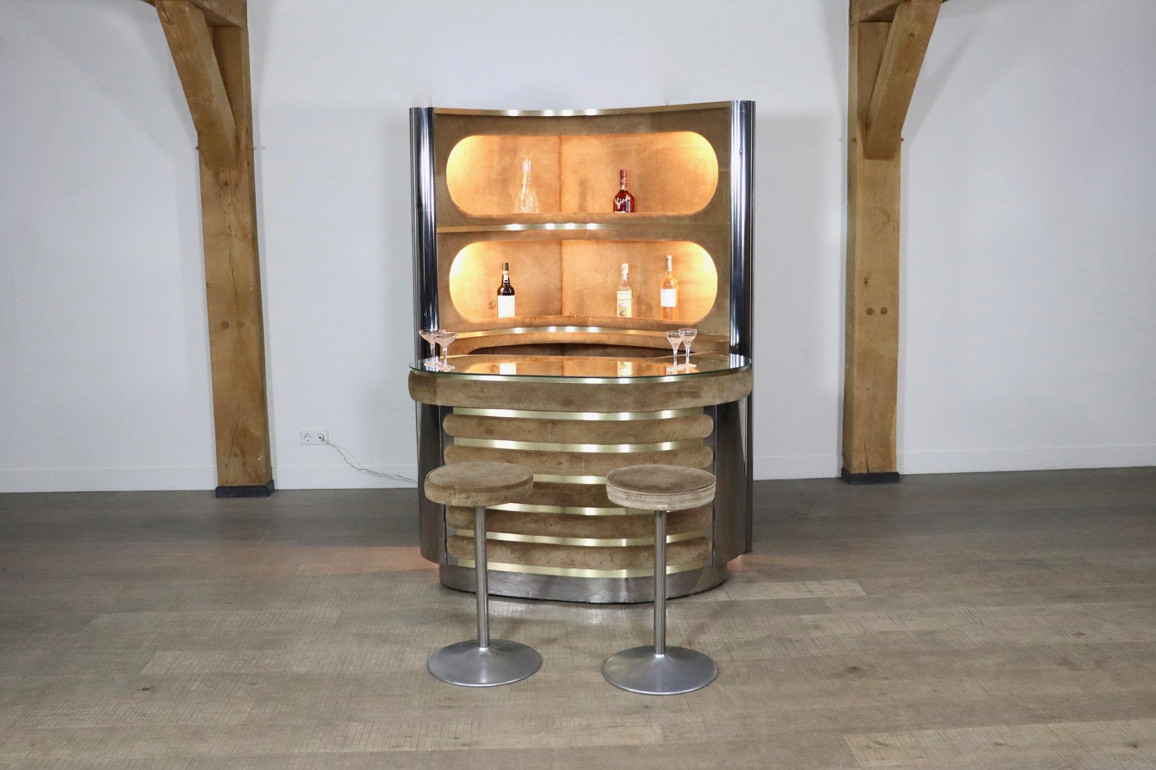 Incredible suede and chrome bar attributed to Willy Rizzo 1970s. With original mirror counter, working lights, original refrigerator and two barstools. With this bar, any room will be elevated to a classy and luxurious space with the perfect