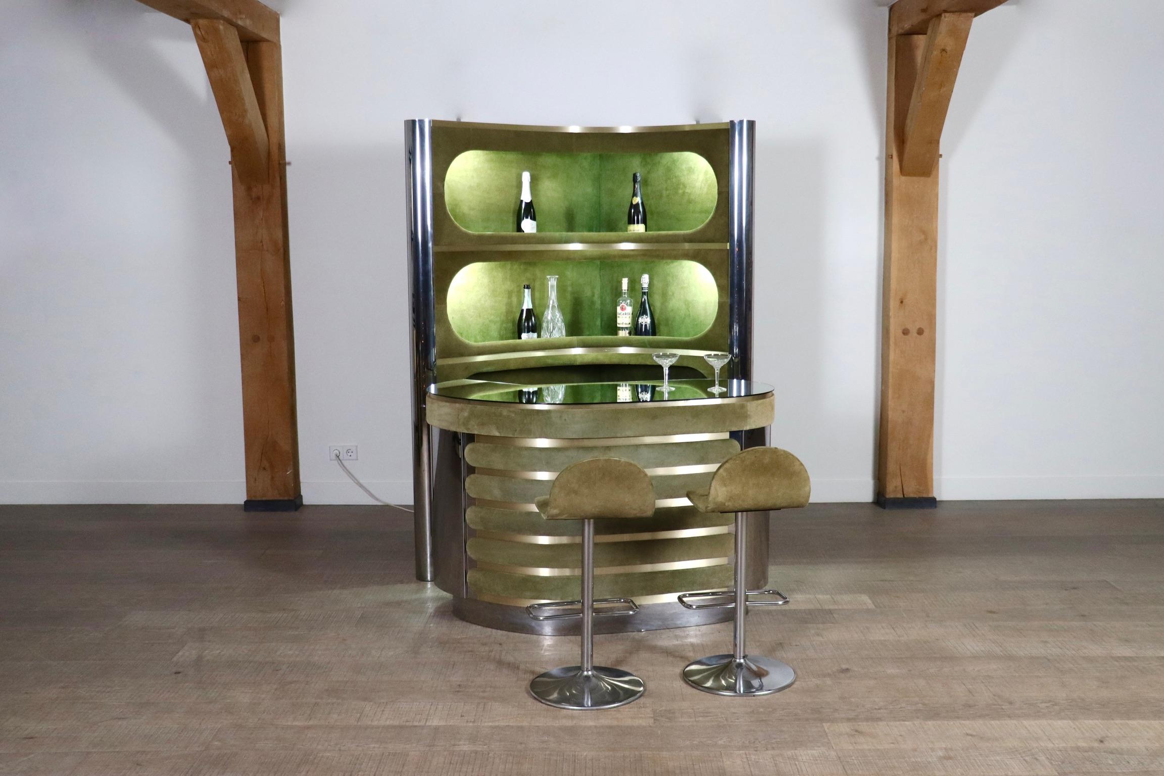 Incredible olive green suede and chrome bar set attributed to Willy Rizzo, Italy, 1970s.

With original mirror counter, working lights, original refrigerator and two matching bar stools. The ultimate seventies combination of olive green suede,