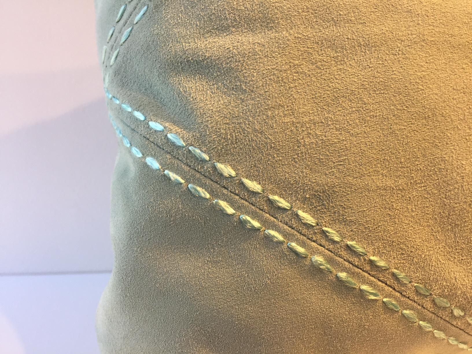 Cushion size: 35x 50cm, front panel very soft suede leather color sea foam green with rhombus detail highlighted with hand saddle stitching, back side panel in fabric, handwoven linen col. sand, cushion cover with cotton lining, concealed zip,