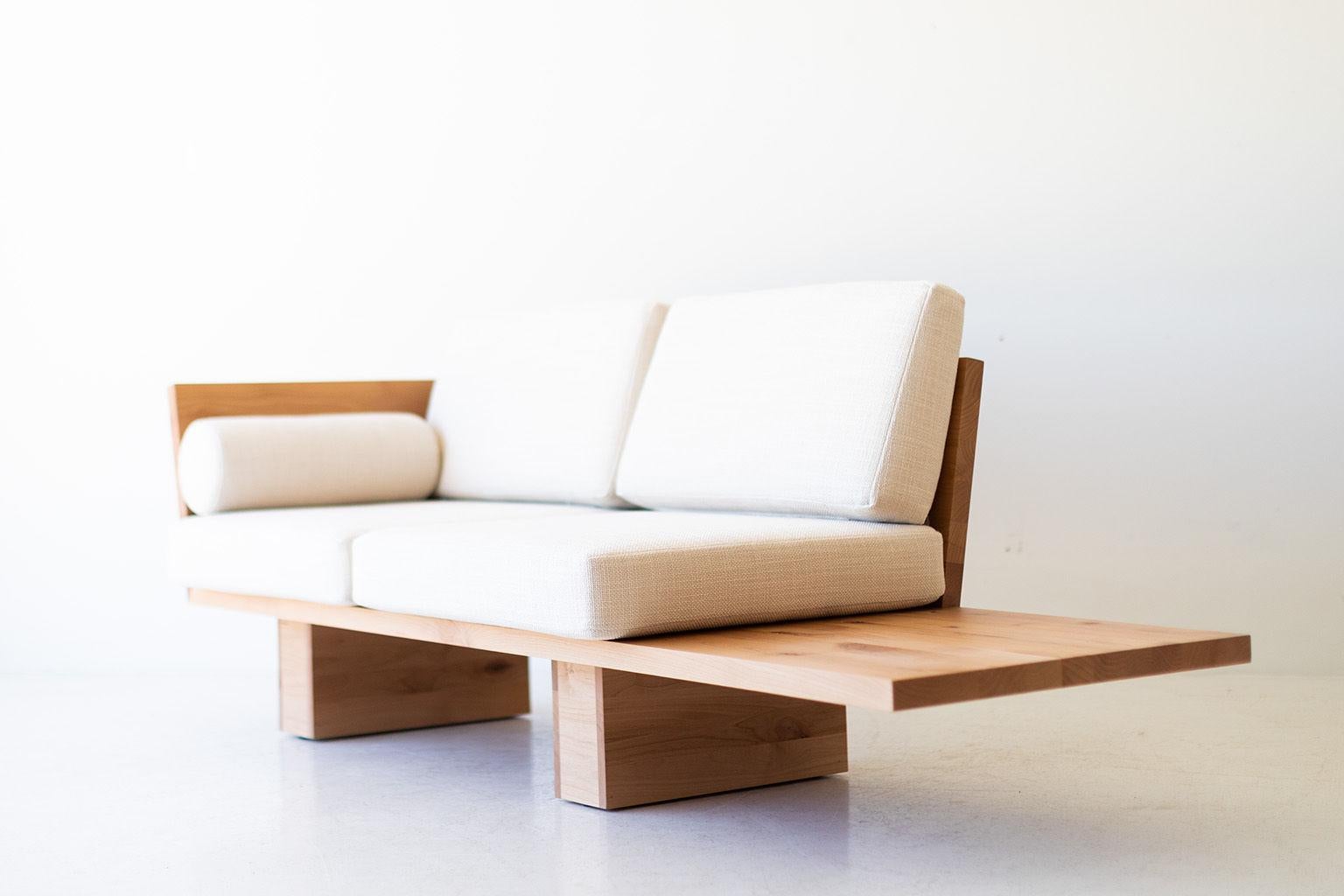 This Suelo modern loveseat is beautifully constructed from solid wood in Ohio, USA. The sofa's silhouette is simple, modern, and sleek with comfortable back and seat cushions. This is the perfect loveseat for any space, indoor or outdoor. The Suelo