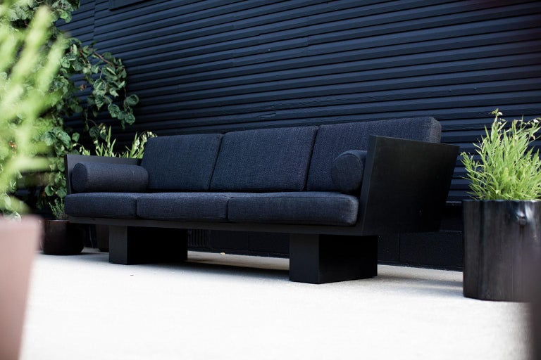 This Suelo modern outdoor sofa is beautifully constructed from solid wood in Ohio, USA. This sofa's silhouette is simple, modern, and sleek with comfortable back and seat cushions. The wood frame is suitable for outdoor conditions and finished with