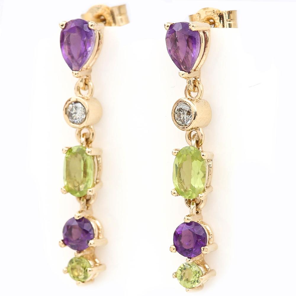 A delightful pair of 9 karat yellow gold Suffragette style drop earrings comprising faceted peridot, amethyst and diamond gemstones. The earrings are set in yellow gold with a chain link to connect the three stones, with a peg and butterfly fitting.