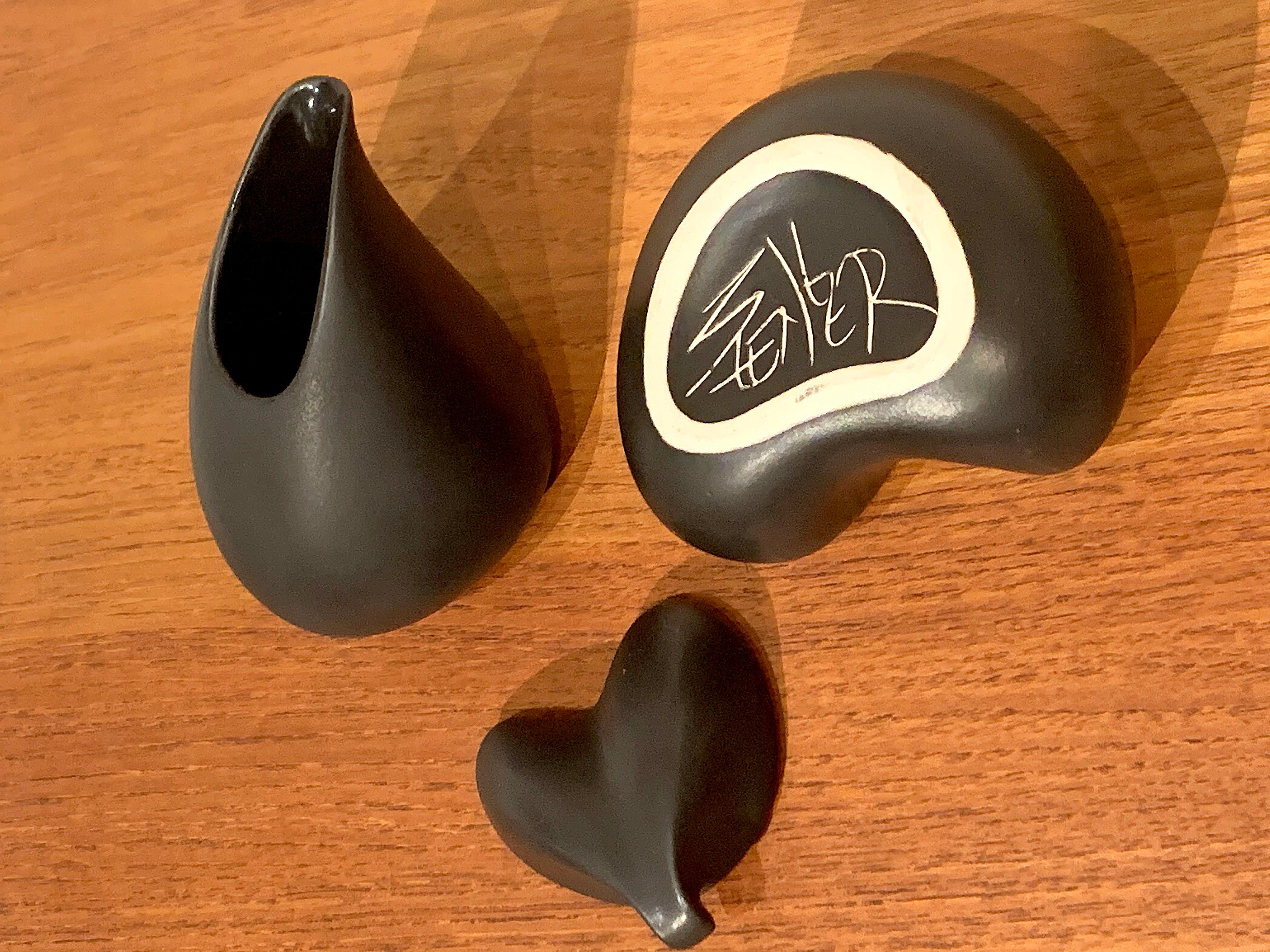 Sugar and cream black ceramic set. Signed, with a very artful signature. We are showing diameter measures for both (each piece is approximate 3.24 x 3.75 inches and 3.5 x 3.75 inches).
    