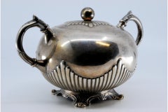 Sugar bowl in fluted silver w/ acanthus leaf handles & resting on 4 raised feet