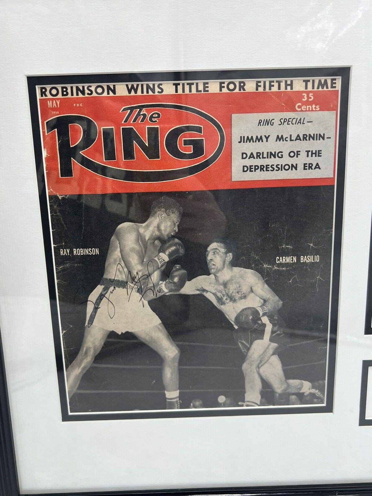 A fantastic displayed Sugar Ray Robinson autographed 1958 edition of “The Ring”. A 1957 Yankee Stadium tag for the fight vs Basilio. 
<br>Approx: 18.5