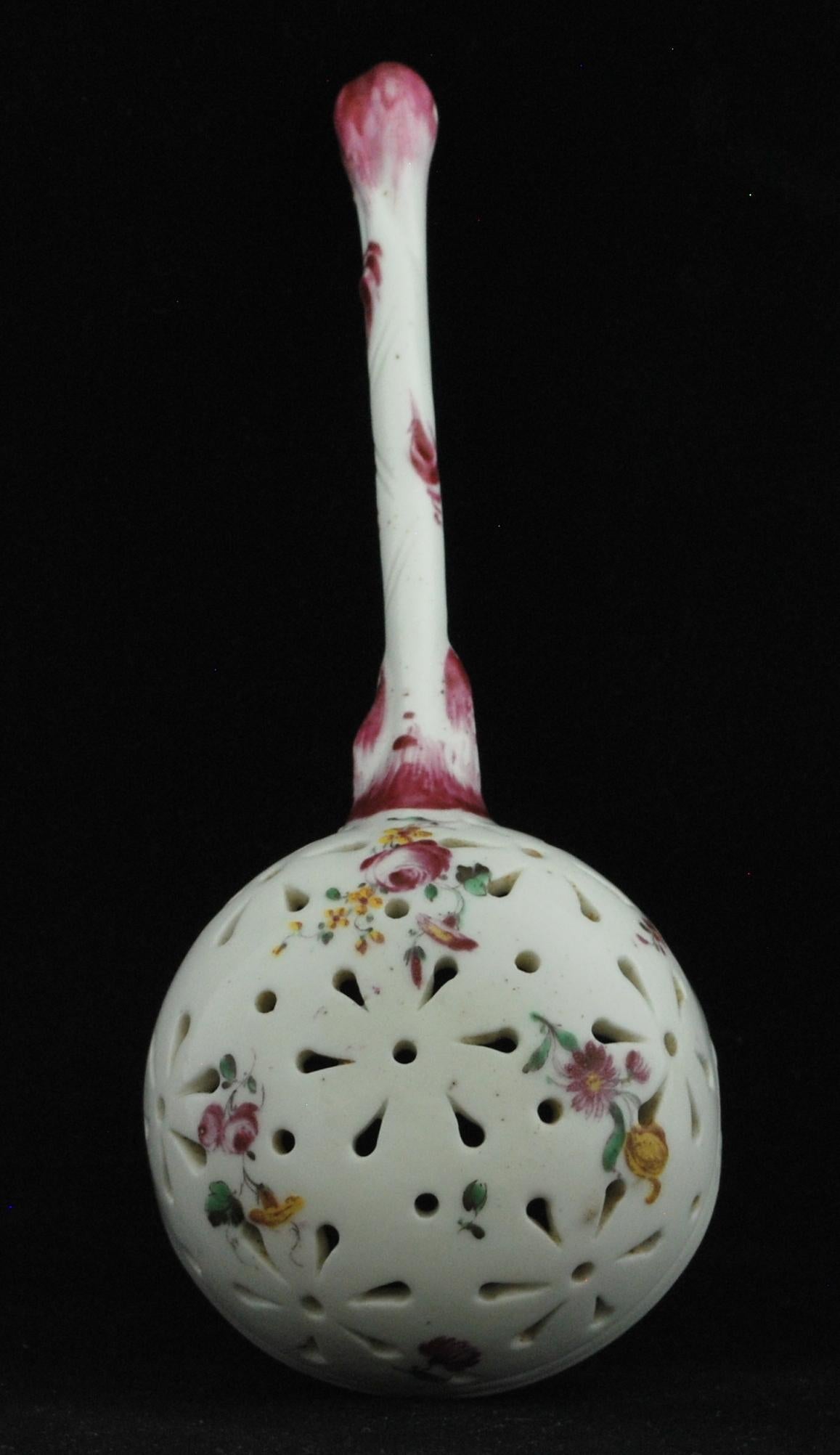 A pierced ladle, probably intended as a sifter as part of a dessert service. The flower painting is particularly fine.