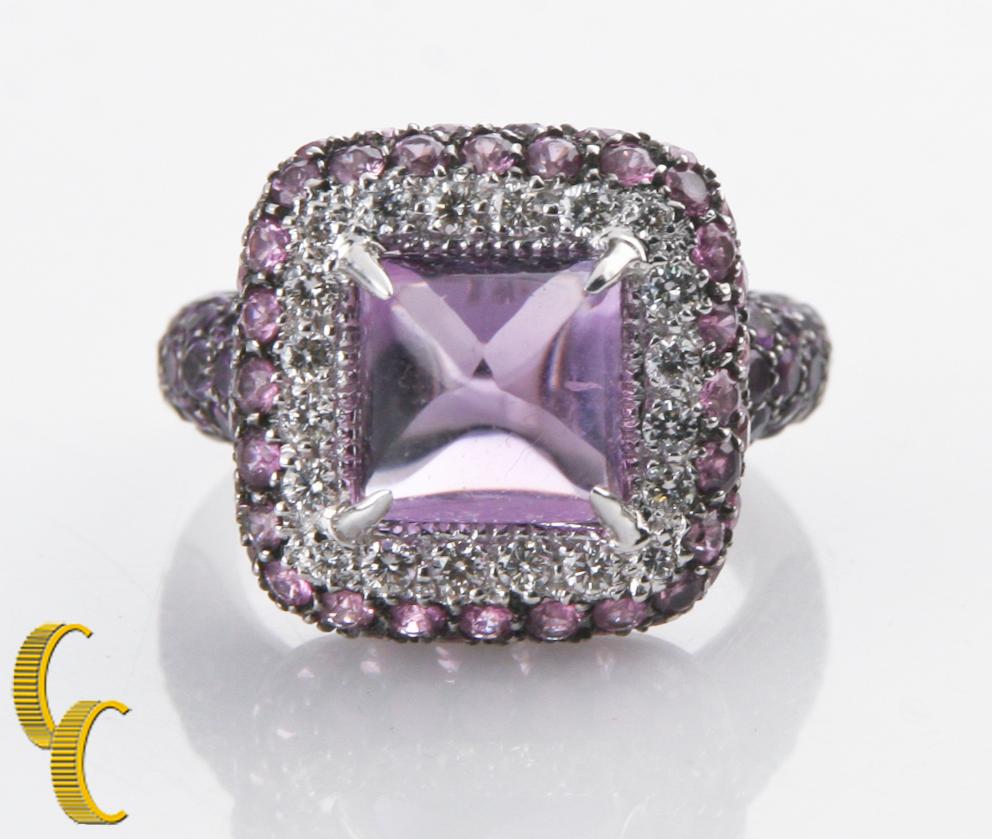 Gorgeous 18k White Gold Ring Featuring Sugarloaf Amethyst Center Stone
Raised Square Gallery Features Pave-Set Round Diamond Bezel and Antiqued Accent Pave-Set Round Pink Sapphires
Antiqued Accent Pave-Set Round Amethyst on Shoulders of
