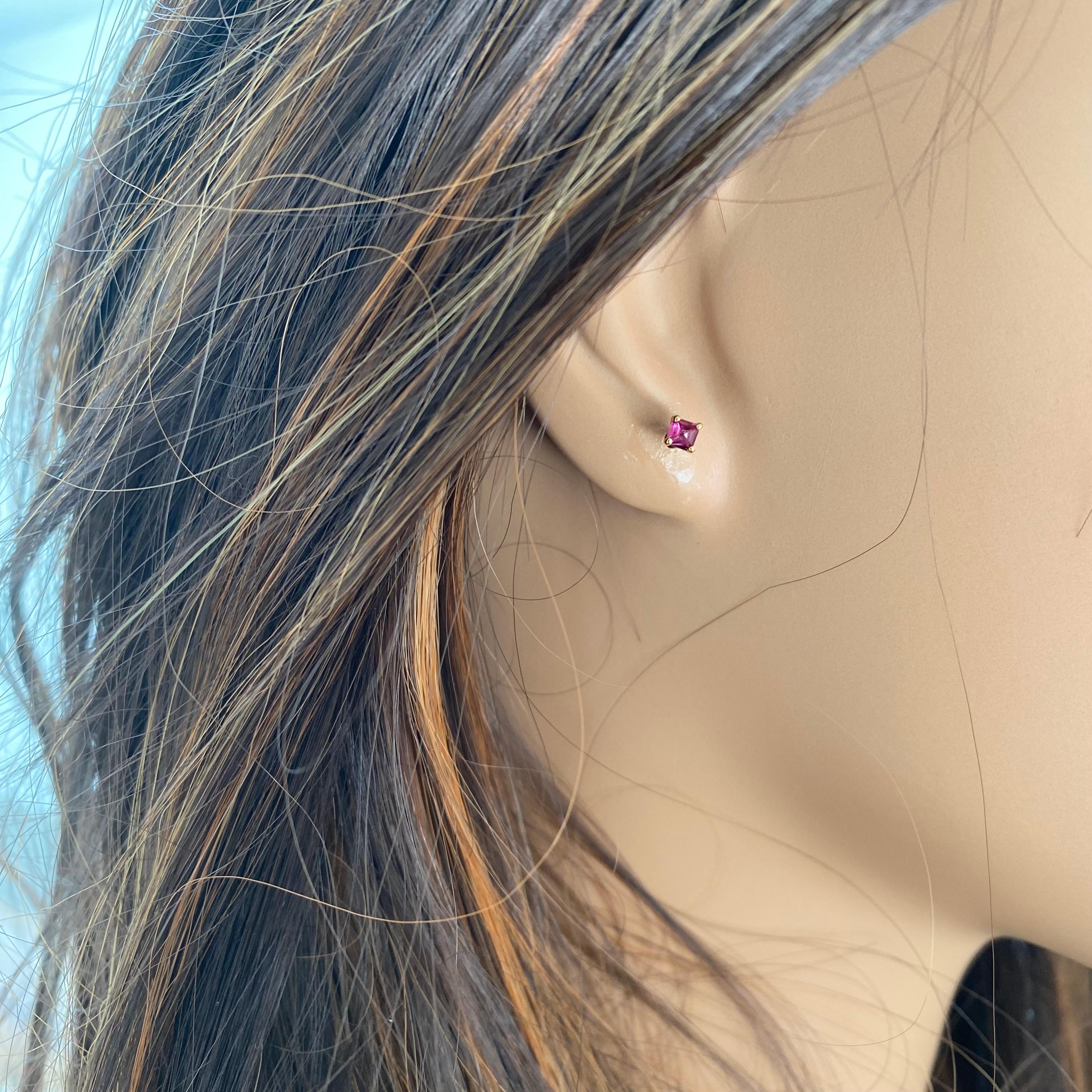 These Sugarloaf Burma Cabochon Ruby stud earrings are a stunning addition to any jewelry collection. Each earring features a vibrant 0.25 carat Ruby set in 14 Karat Yellow Gold. The Rubies are elegantly cabochon cut, showcasing their natural beauty