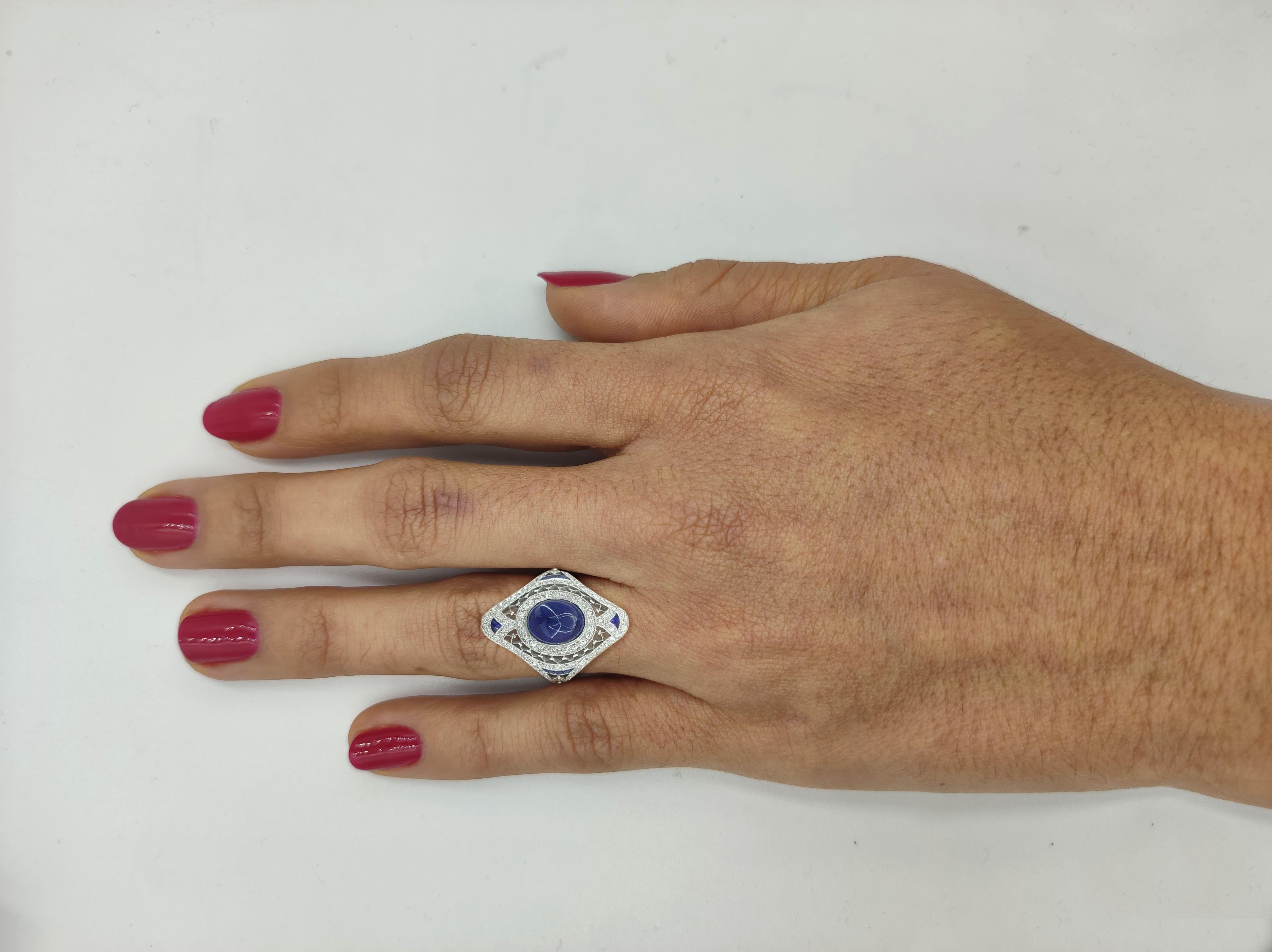 Sugarloaf Cabochon Blue Sapphire & Old European Cut Diamond  Ring. 



The ring weighs 6.2 grams, size 6.25, the Center stone is a natural Sugarloaf Cabochon Shaped Blue Sapphire weighing approximately 5 ct, measuring 9.57x7.70x6.40mm, 8 custom cut
