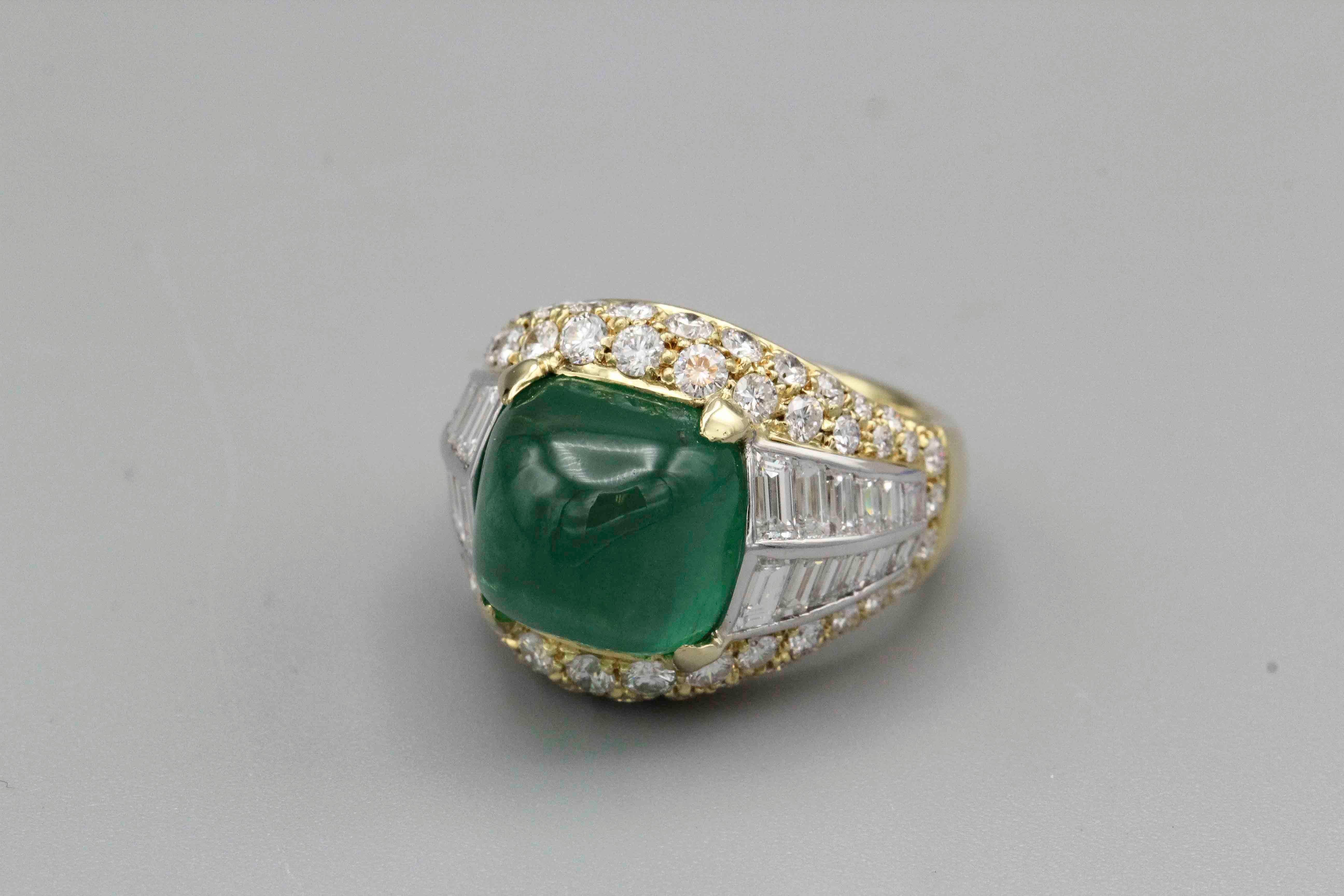 Fine emerald, diamond and 18K gold in the manner of the Bulgari Trombino rings.. It features a beautiful and richly saturated sugarloaf cabochon emerald of over 8 carats in weight; further featuring high grade round brilliant cut and baguette cut