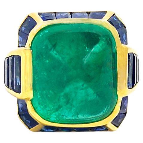 Sugarloaf Cabochon Emerald 10.38 carats with Blue Sapphire 5.20 carats Ring set in 18K Gold Settings
18K Gold Settings

Width:  1.5 cm 
Length: 1.8 cm
Ring Size: 54
Total Weight: 12.42 grams

