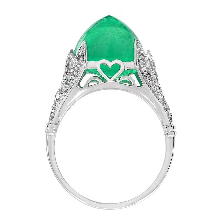 Discover our extraordinary one-of-a-kind Cabochon Colombian Emerald ring of all time! A magnificent sugarloaf shape Colombian emerald is the colorful centerpiece of this gorgeous antique bauble, elegantly handcrafted in gold. The gracefully scrolled