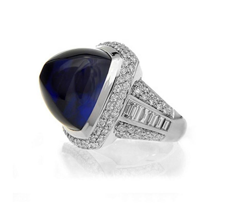 SUGARLOAF TANZANITE AND DIAMOND RING A lofty sugarloaf Tanzanite of the finest quality is the centerpiece of this dramatic design. Item: # 01639 Metal: 18k W Color Weight: 41.93 ct. Diamond Weight: 4.10 ct.
