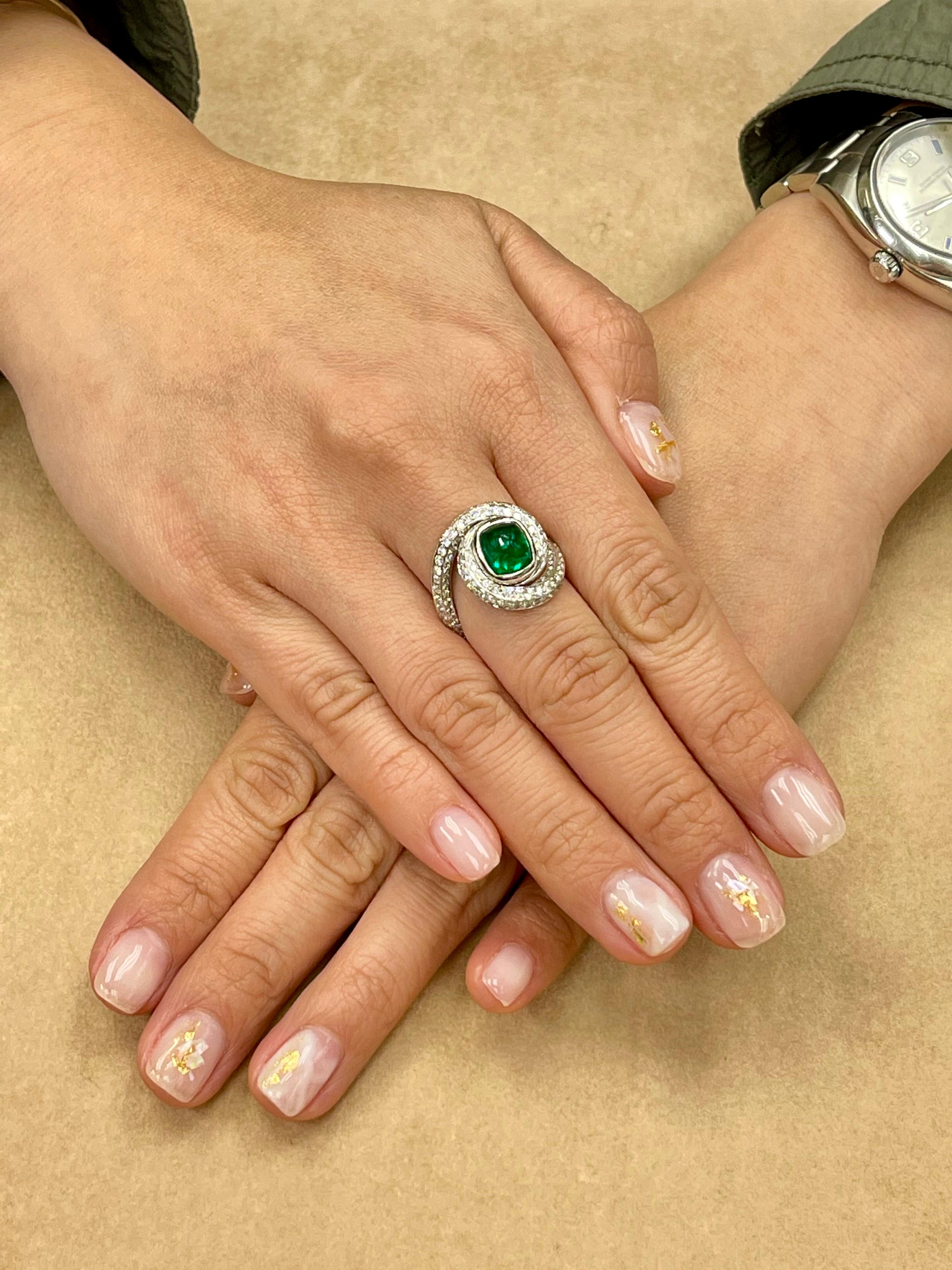 Here is a nice sugarloaf Emerald and diamond ring. The ring is set in 18k white gold and white diamonds. The center emerald is 2.07cts. There are 183 small white diamonds totaling 1.82cts surrounding the ring. The emerald has the vivid green color