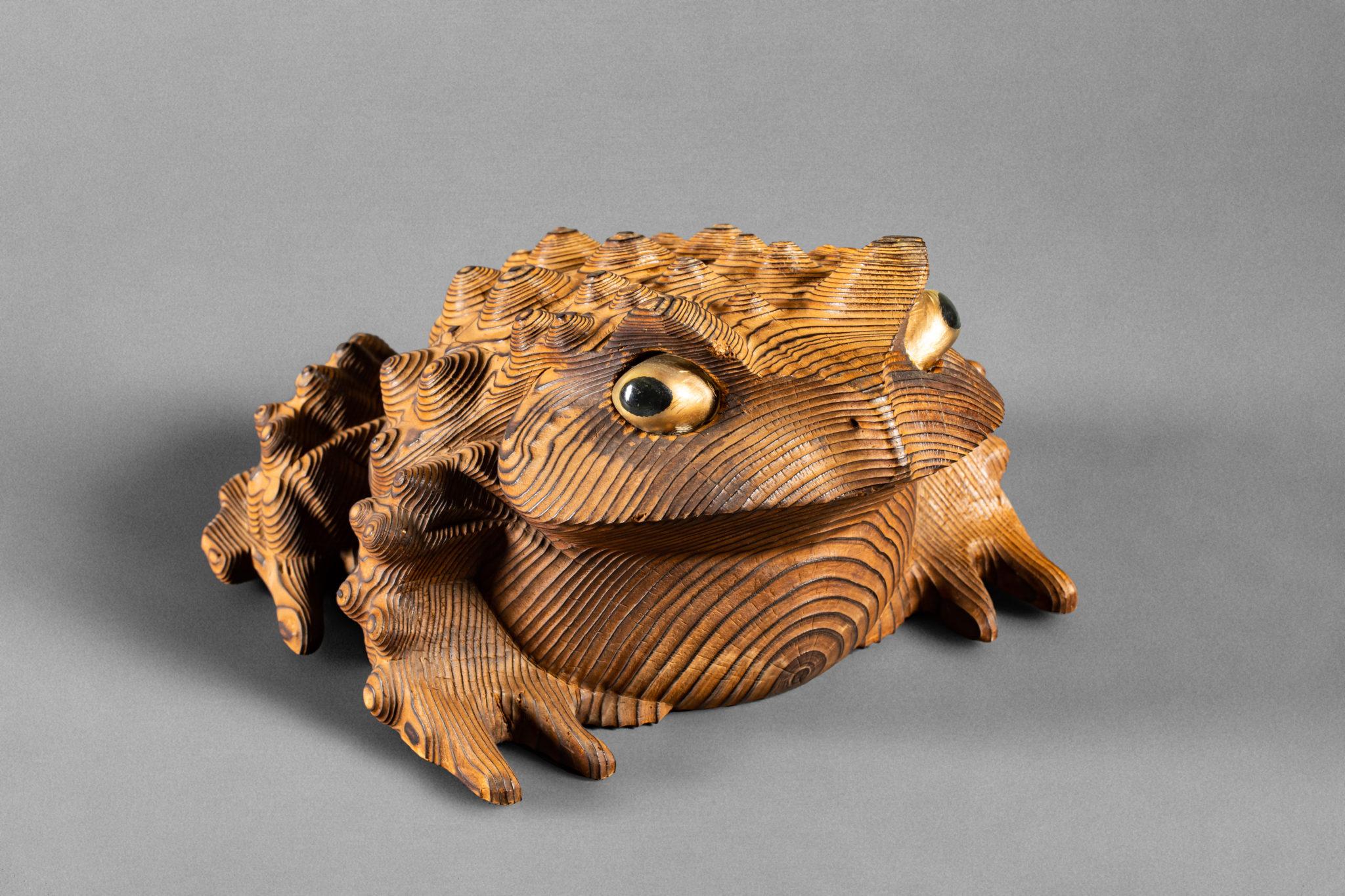 Wood carving of a frog with glass eyes and wonderful patina.