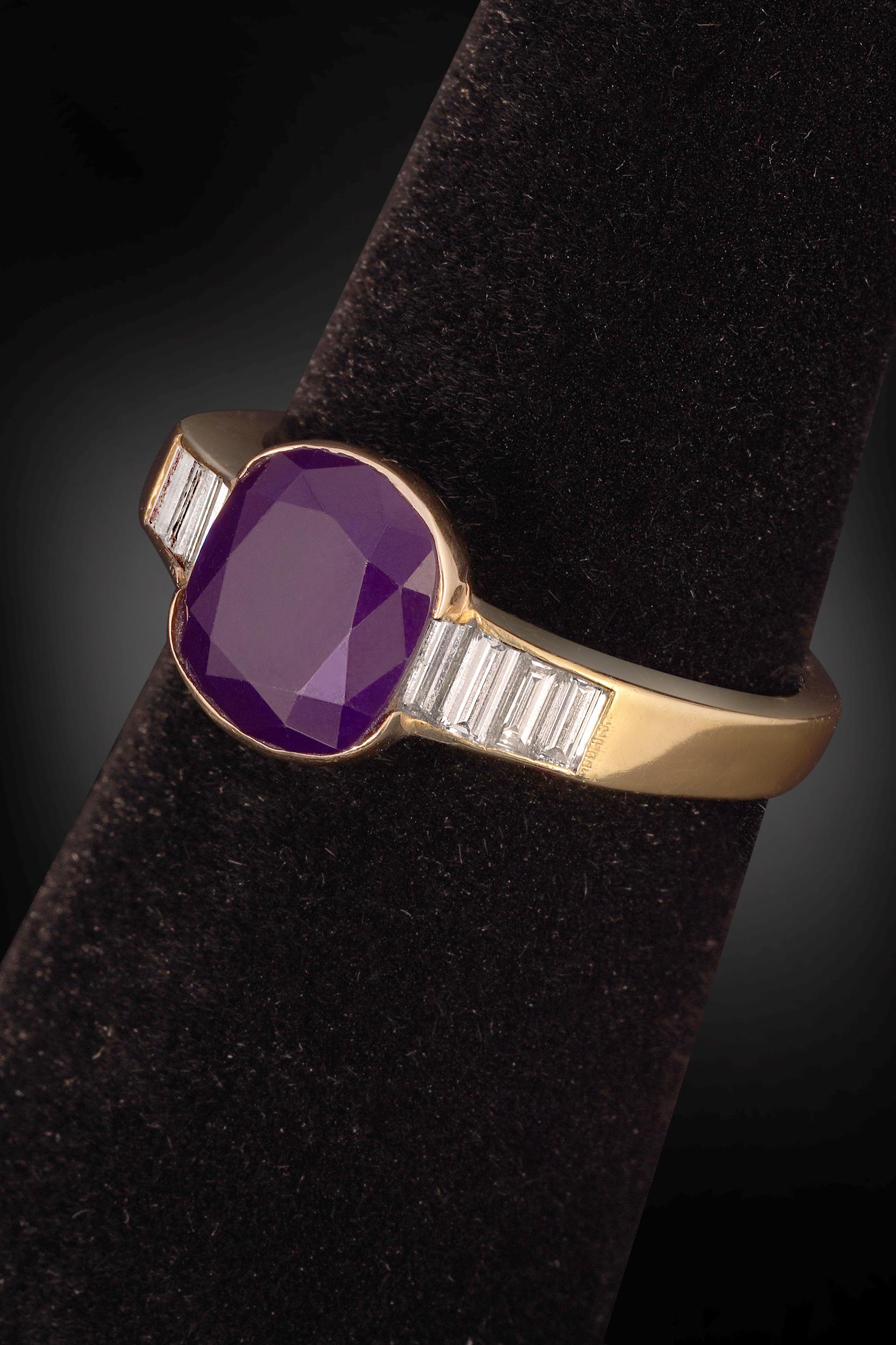 A modest yet stunning piece. This Sugilite ring is the highest grade of Sugilite and is no longer obtainable on the open market. Framing the faceted Sugilite are beautiful accent baguettes of diamonds; set in 18 karat gold. 

Material – 18 K Gold,