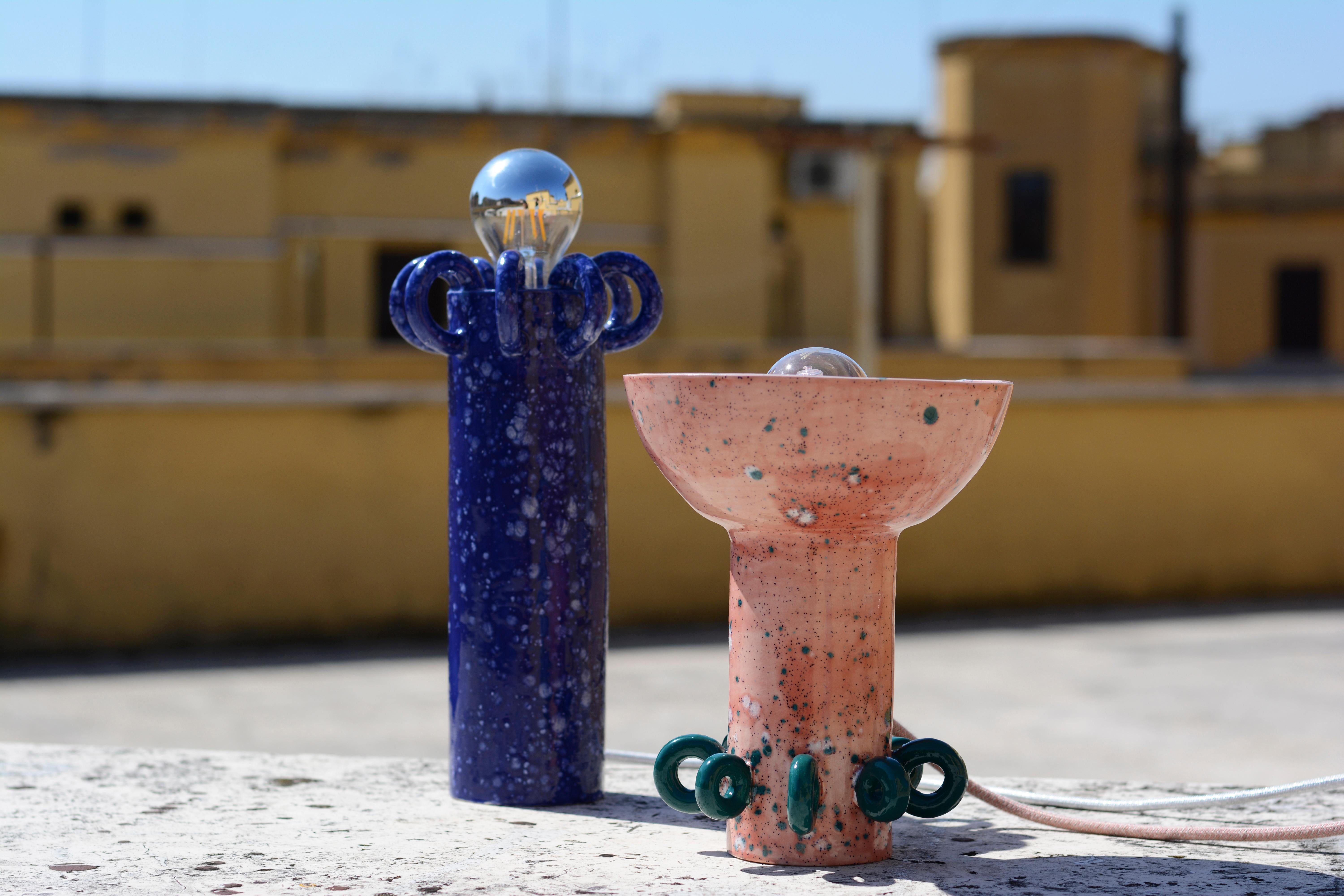 Sugo and Riva set of 2 Ceramic table lamps by Arianna De Luca
The Riva Lamp (blue) dimensions are H 30 cm x Diam 10 cm. Cable length: 1.5 m.
The Sugo Lamp (pink) dimensions are H 24 cm x Diam 16 cm. Cable length: 1.5 mCable length: 1.5 m.
Materials: