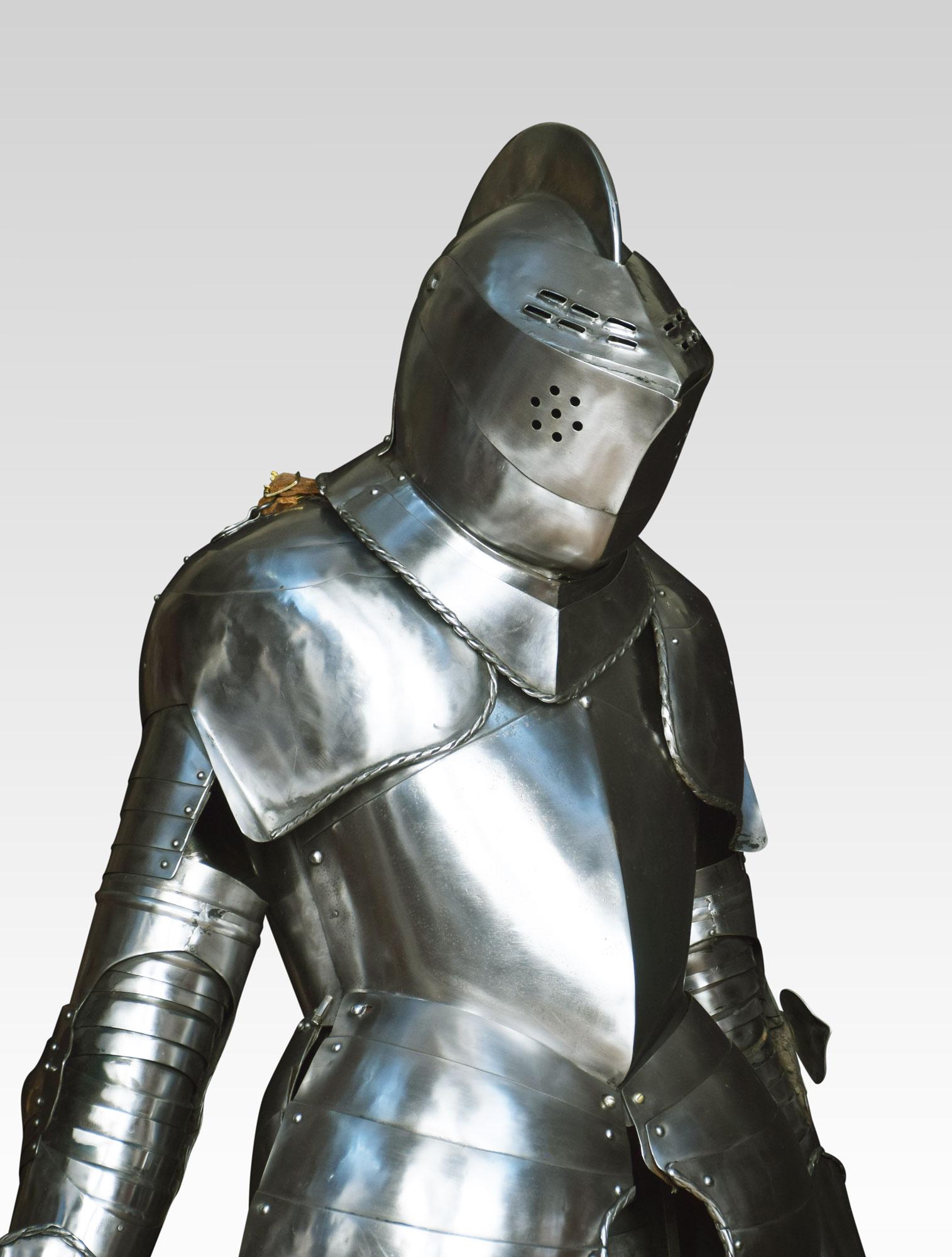 A suit of 16th century style armour, the helmet with pierced visor, raised comb applied and twist border collar, two-piece breastplate with medial ridge, twist border shoulder plates inlet for overhead combat, articulated arm plates, gauntlets with
