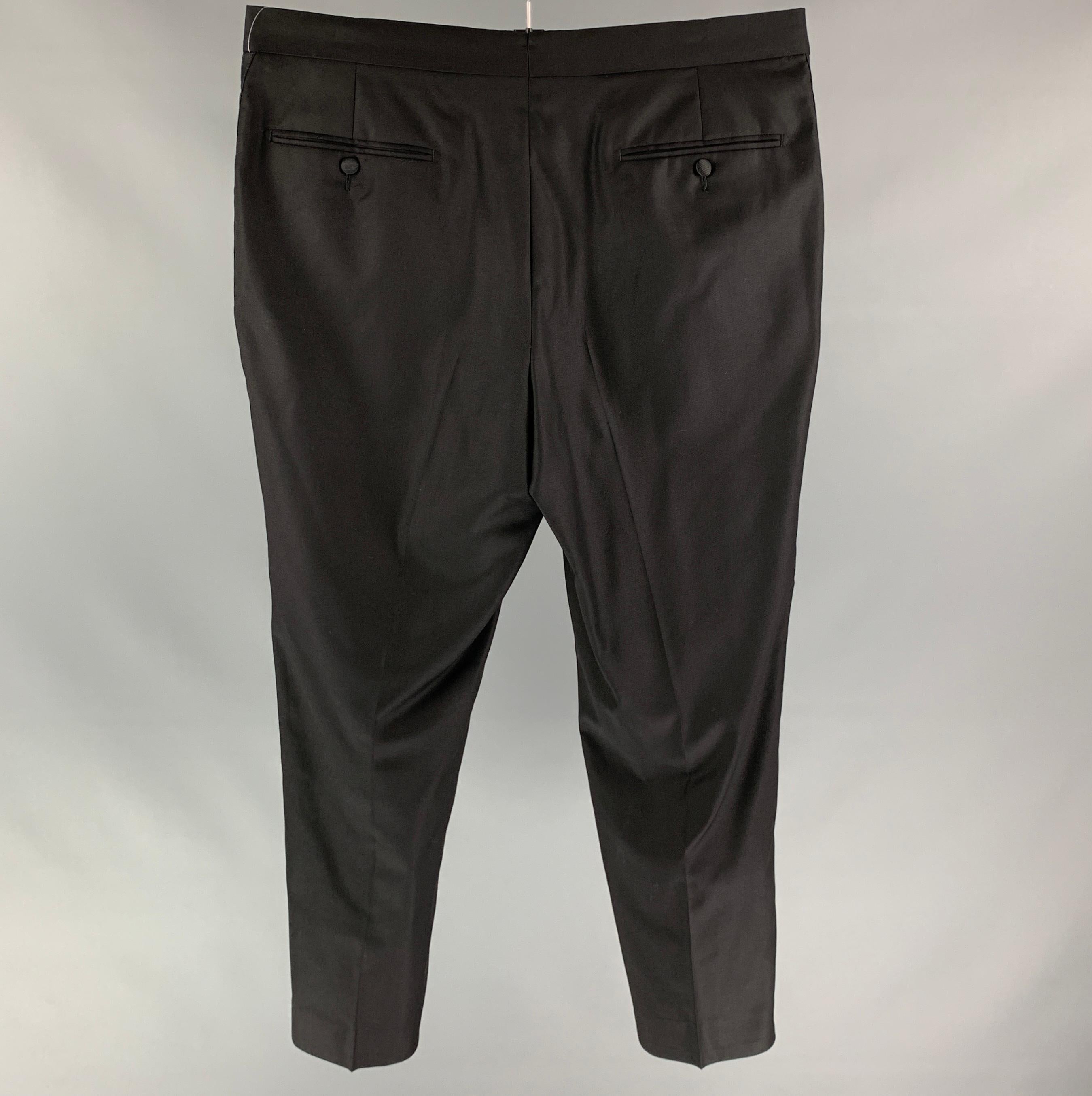 SUIT SUPPLY tuxedo dress pants comes in a black wool featuring a flat front, straight leg, front tab, and a zip fly closure.

Very Good Pre-Owned Condition.
Marked: 52

Measurements:

Waist: 36 in.
Rise: 10.5 in.
Inseam: 30 in.  
SKU: