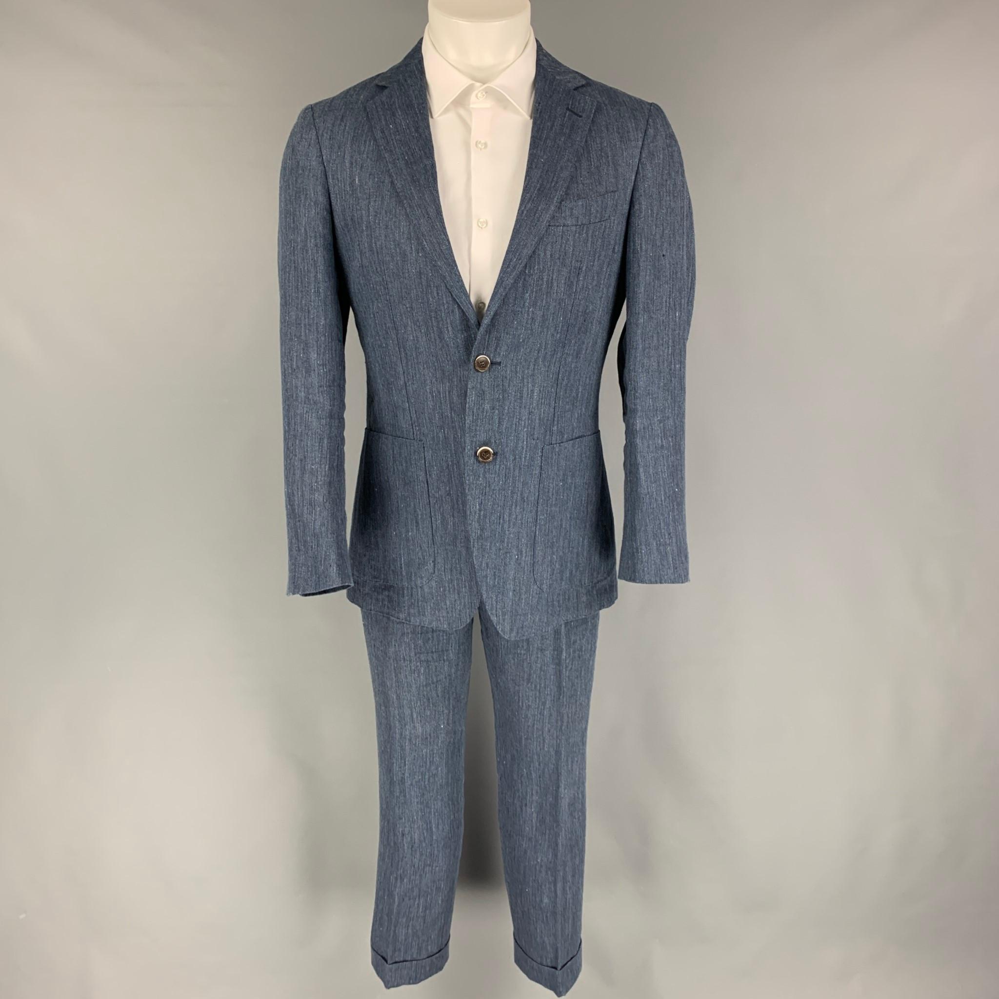 SUIT SUPPLY suit comes in a blue herringbone linen with half liner and includes a single breasted, double button sport coat with notch lapel and matching flat front trousers.

Very Good Pre-Owned Condition.
Marked: