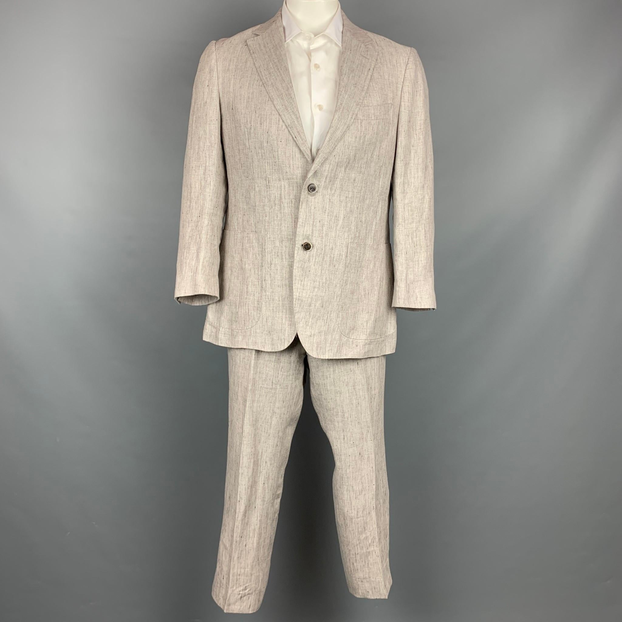 SUIT SUPPLY suit comes in a oatmeal textured linen with a half liner and includes a single breasted, two button sport coat with notch lapel and matching flat front trousers.

Very Good Pre-Owned Condition.
Marked: Jacket: 54
Pants: