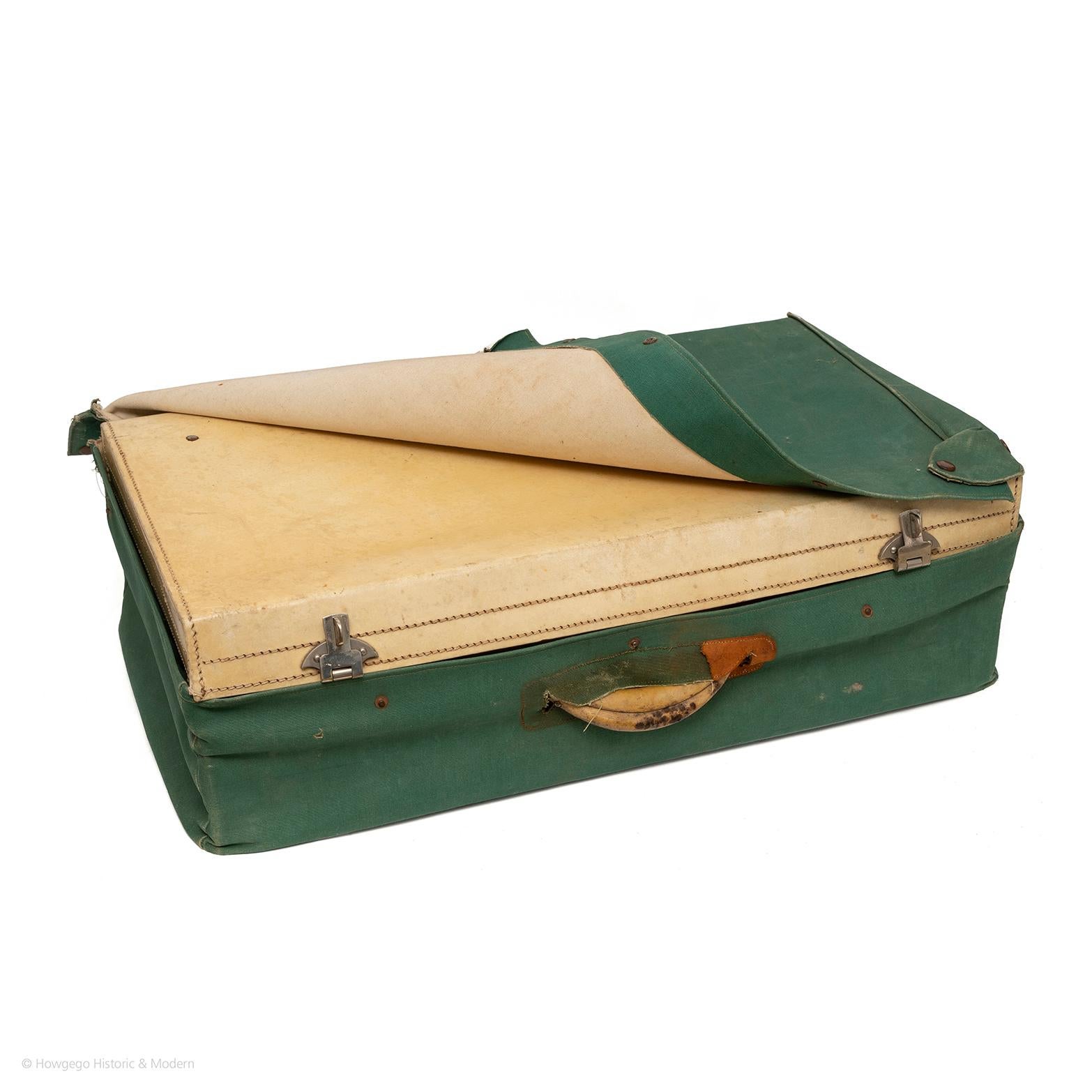 1920's French, vellum suitcase with nickel locking fittings and key in rare, exceptional condition protected by its original green canvas fitted cover which is very unusual as these are normally worn away or lost. The only visible external wear is