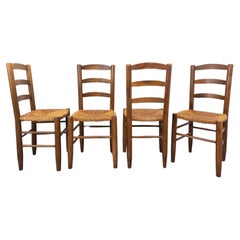 Suite de 4 chaises brutalistes vintage en bois et paille des années 60