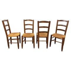 Suite de 4 chaises brutalistes vintage en bois et paille des années 60