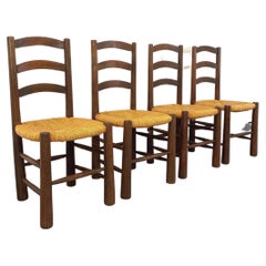 Suite de 4 chaises brutalistes vintage Georges The en bois et paille