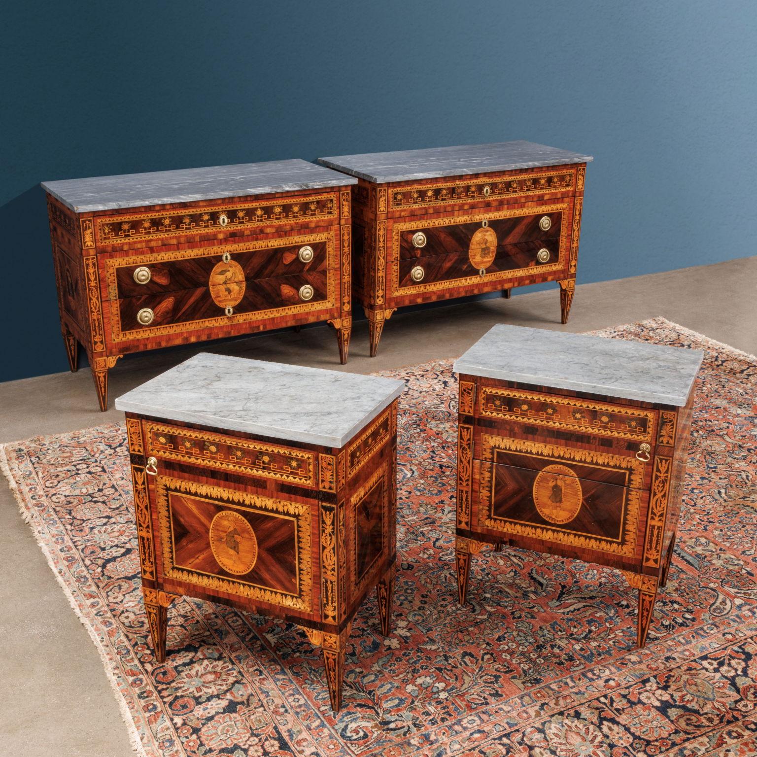 Suite consisting of pair of three-drawer dressers and two door-opening nightstands, one of which has a pull-out compartment; veneered in four-part bois de violette with borders in bois de rose, walnut and with medallion reserves inlaid in maple,