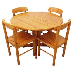 Suite d'une table ronde avec rallonge et 4 chaises vintage en pin des années 60