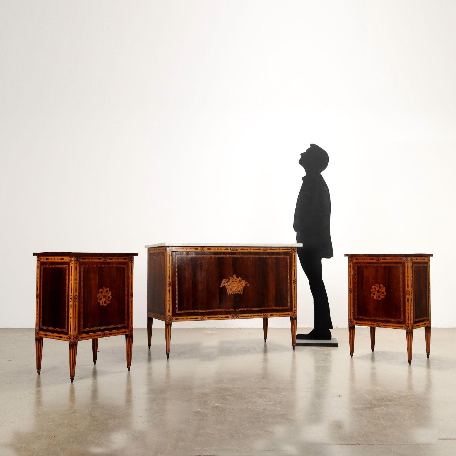 Tuscan neoclassical suite, consisting of dresser and two nightstands. The dresser features a drop-down door that conceals three drawers inside with bronze pulls, and the nightstands with drop-down tops and openable doors conceal the compartments