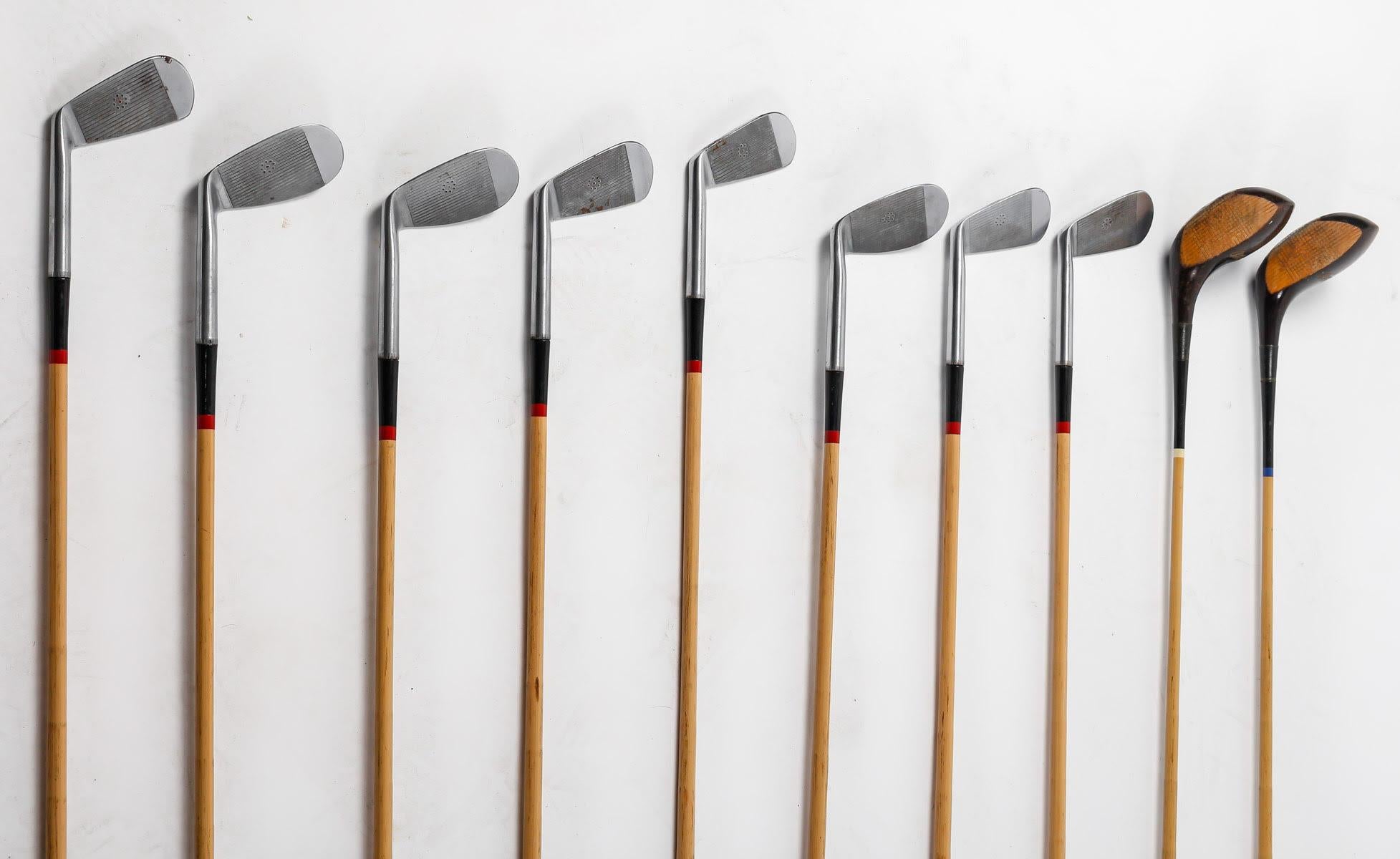 Suite of 10 1930s Golf Clubs.

Suite of 10 vintage golf clubs, wooden handles, from the 1930s, including 8 iron and 2 wood.

Dimensions each: h: 105cm, w: 10cm, d: 7cm