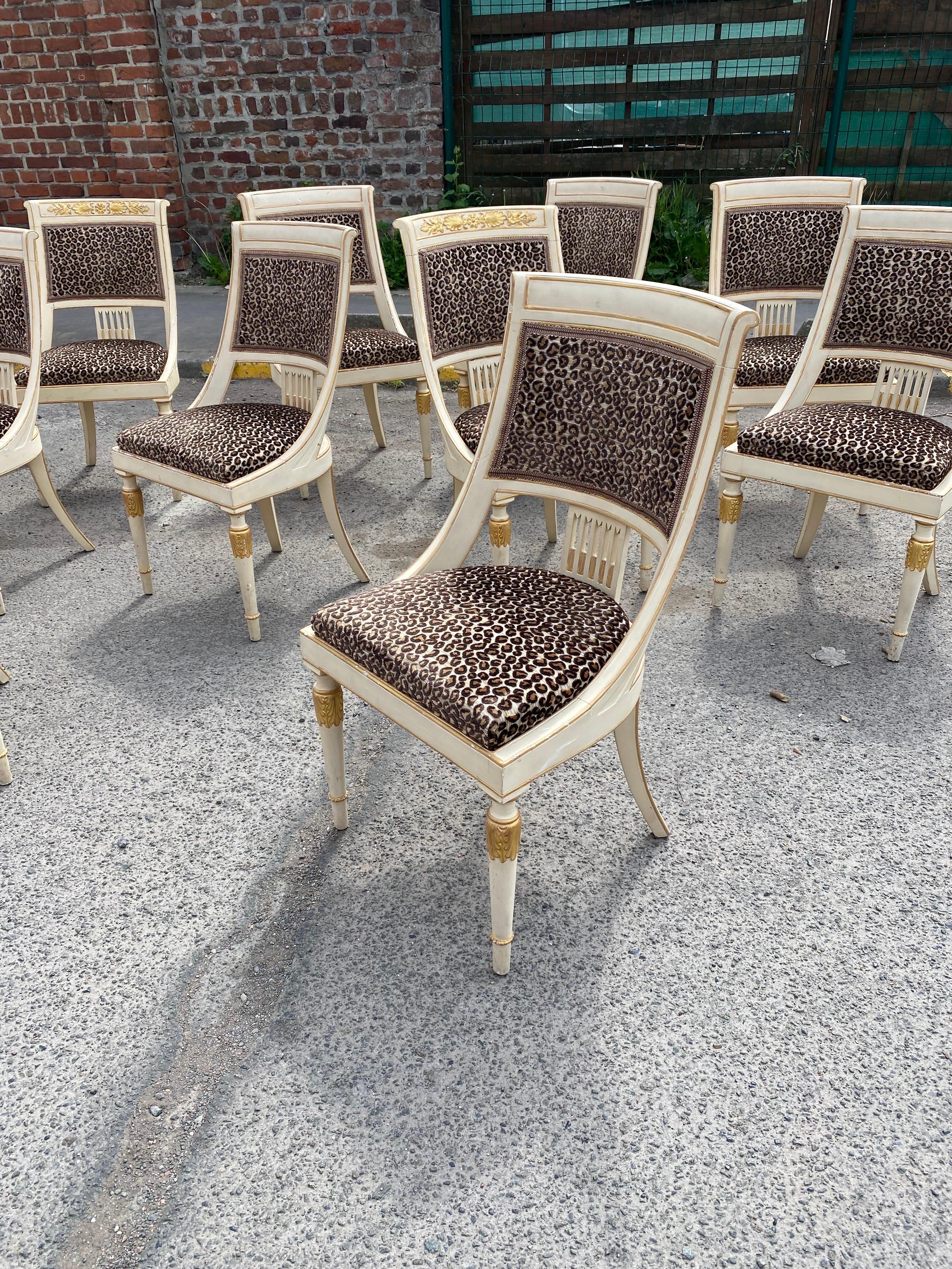 Suite of 12 Empire style chairs circa 1960/1970
in the style of Maison Romeo in Paris;
2 chairs have a golden frieze at the top of the backrest;
small paint chips, some fabric is a little 