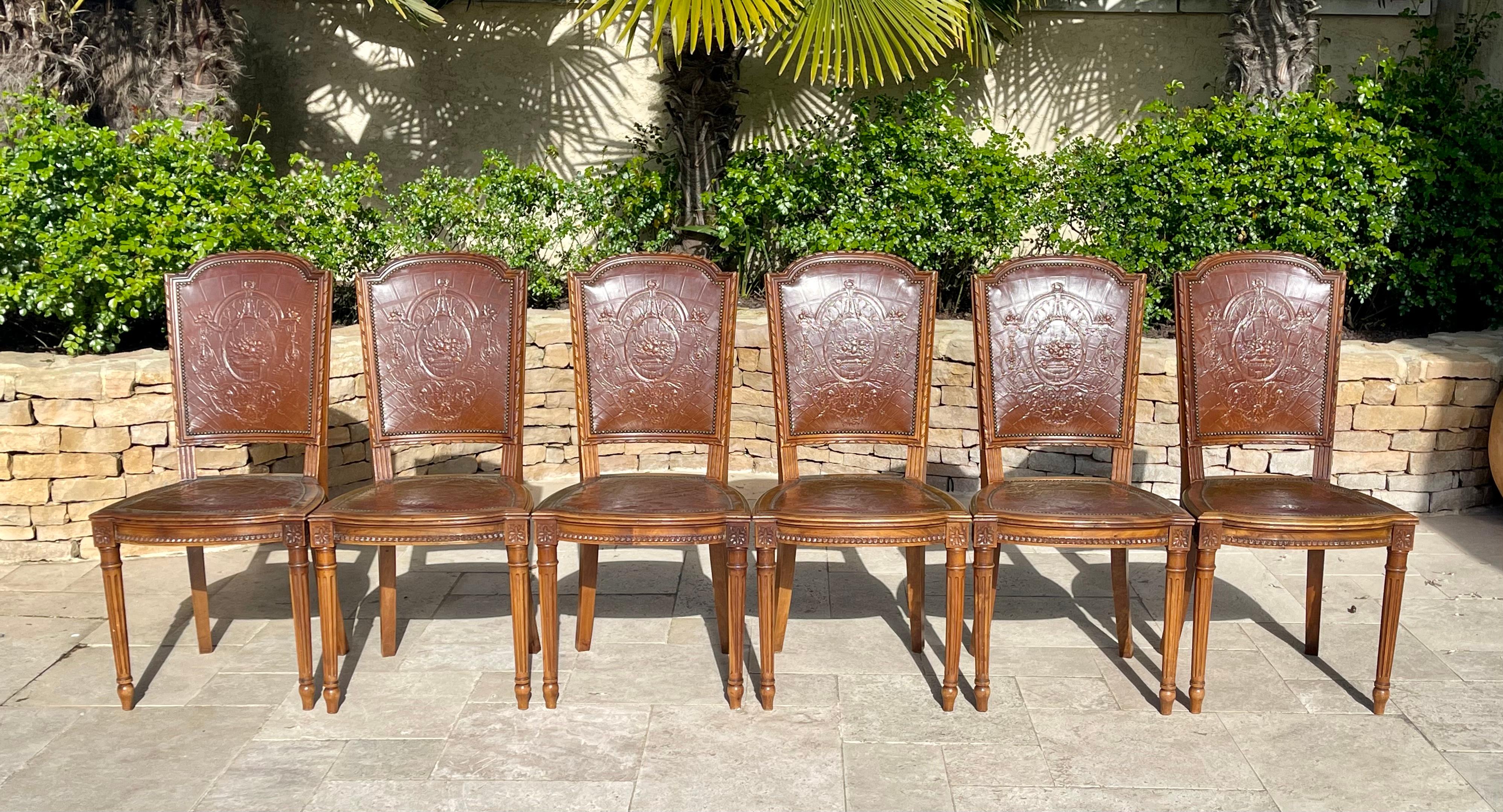 Suite of 6 Louis XVI style chairs in carved walnut covered in embossed brown leather, Cordoba leather. This series is very elegant and in very good condition.

Dimensions
Total height 96cm
Seat height 45cm
Width 47cm
Depth 45cm