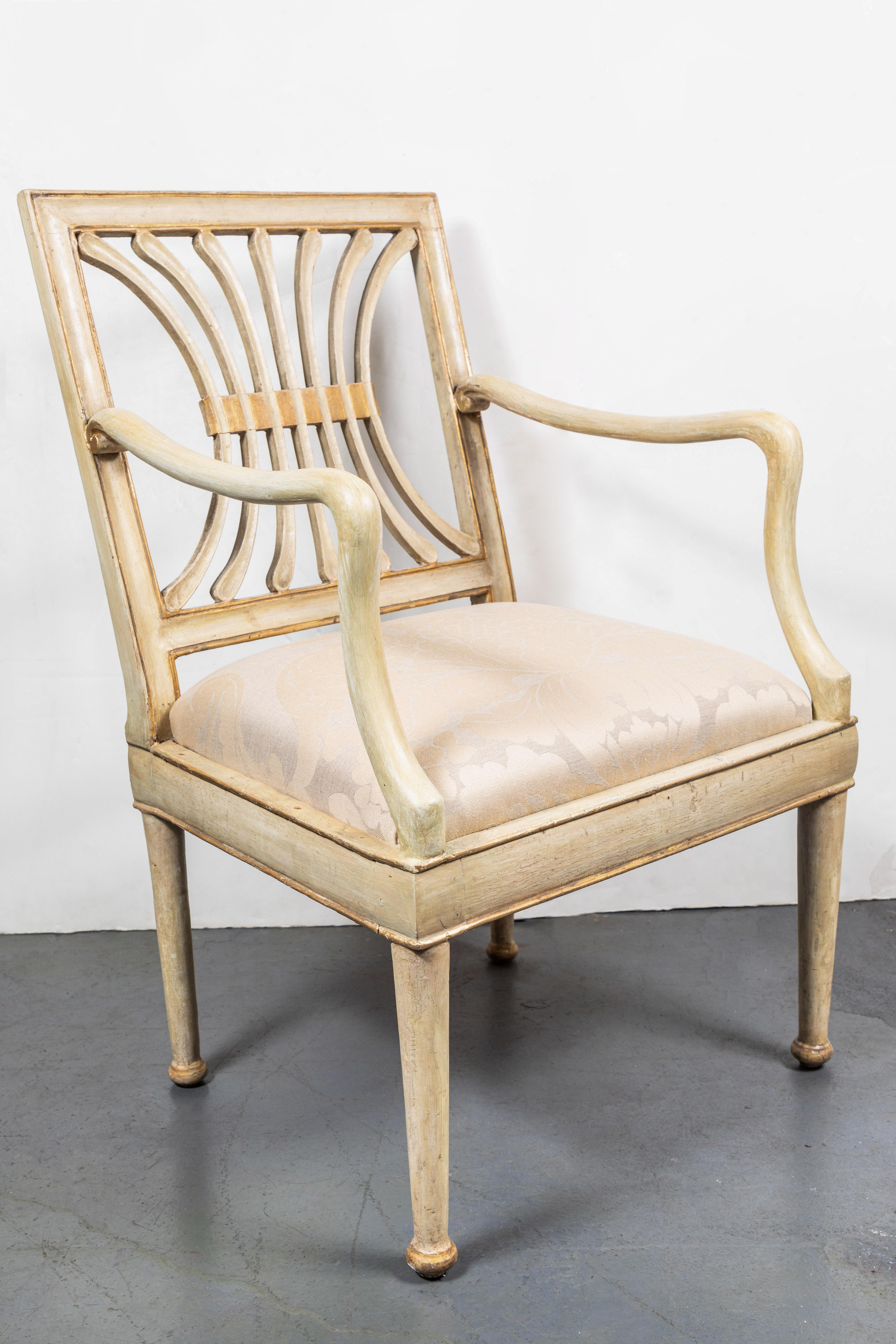 Sechs handgeschnitzte, bemalte und paketvergoldete italienische Stühle aus der Jahrhundertwende in creme. Die durchbrochene, skulpturale Rückenplatte und die geschwungenen Arme über den konisch zulaufenden Beinen. Erworben aus einem Privatbesitz in