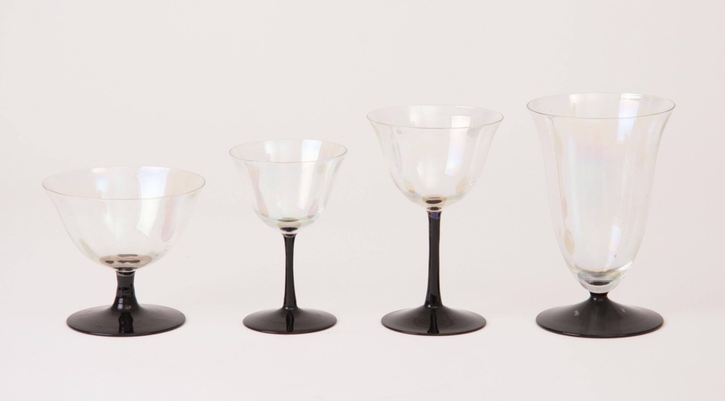 Beautiful Art Deco cocktail glasses with Iridescent bowls on black tulip stems
6 water - H 14cm, W 9cm, D 9cm
6 wine - H 14cm, W 9cm, D 9cm
6 dessert wine - H 11cm, W 8cm, D 8cm
6 coupe - H 9cm, W 10cm, D 10cm
French, circa 1930.