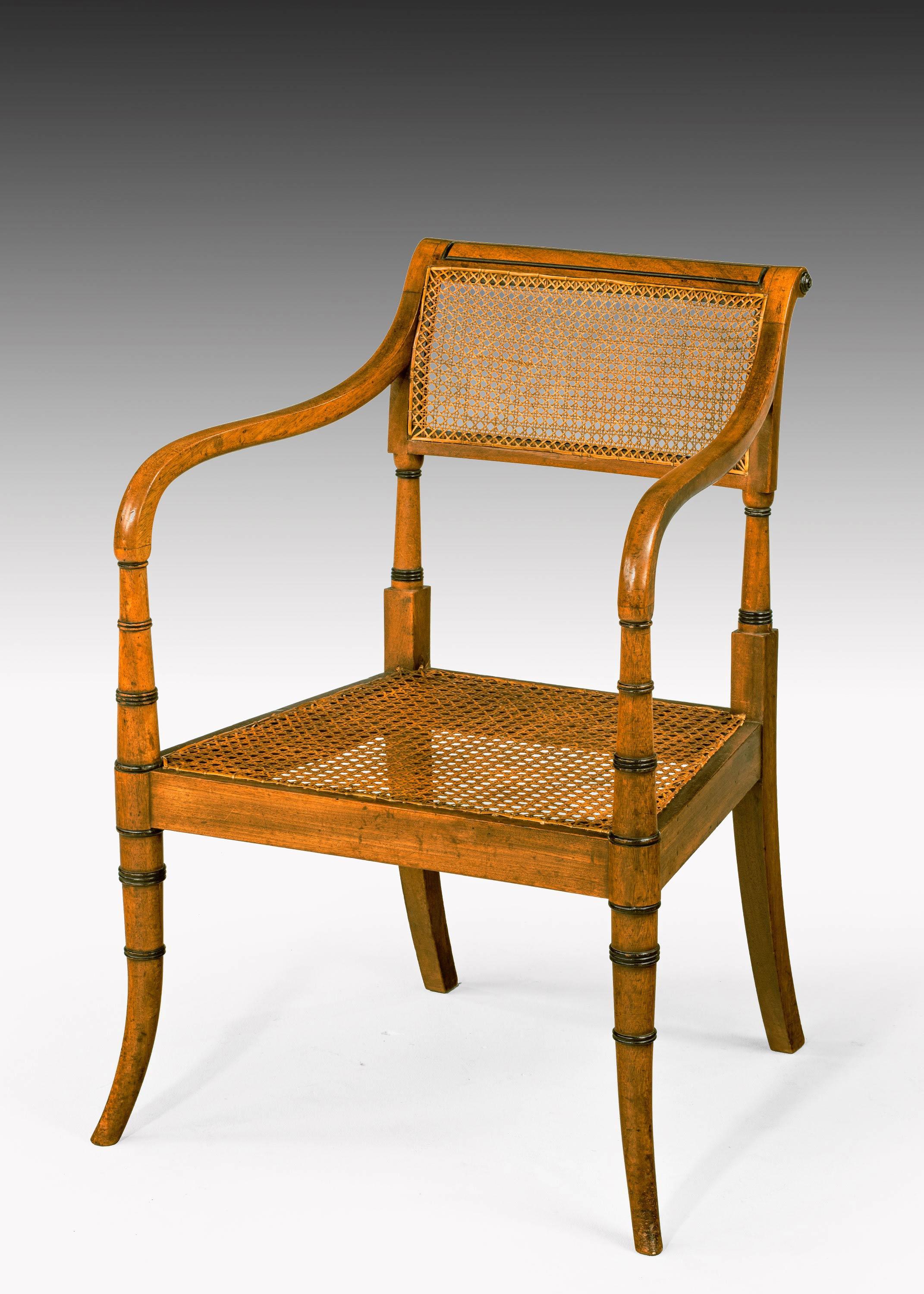 An unusual and variacant suite of eight Regency period mahogany chairs. Consisting of four elbow chairs and four singles. With fine period caning. The supports with an unusual flare to the bottom section and ebonised ring turnings. 

Seat height