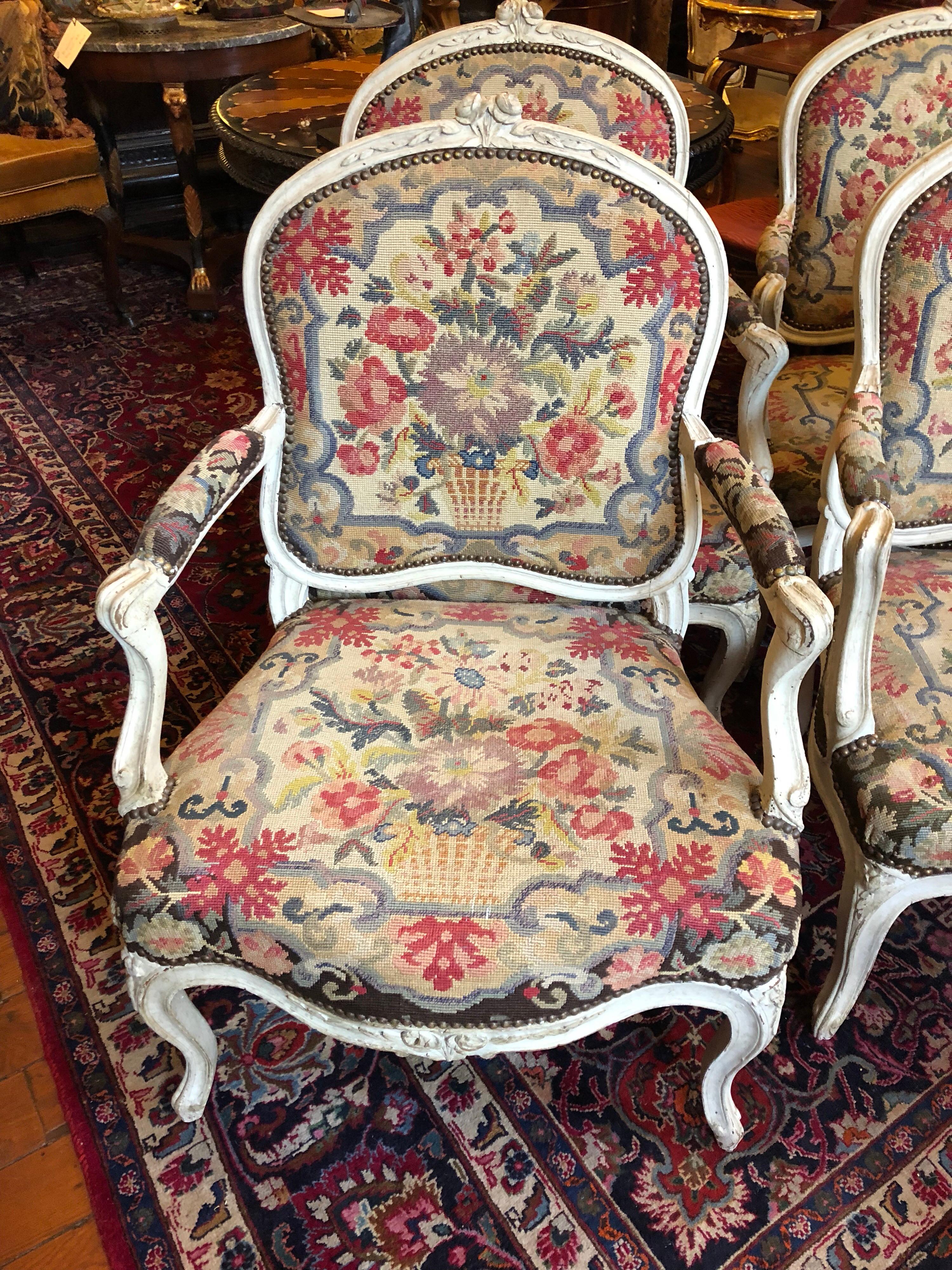 Exceptional suite of four 18th century pained Louis XV fauteuil with original needle work. The needle work has been removed, repaired and put back on. All in exceptional condition. 
each joint is pegged consistent with an 18th century
