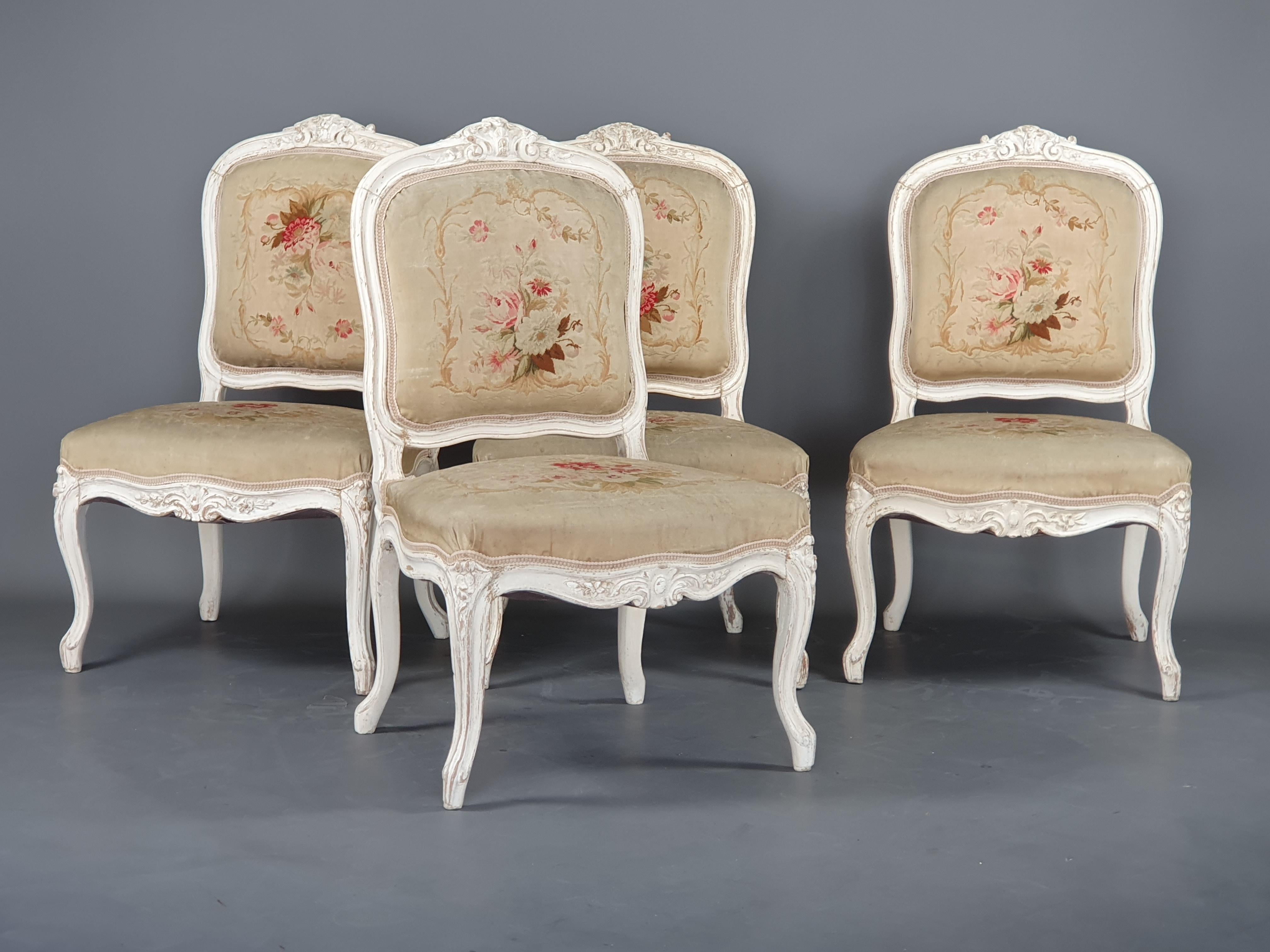 Suite of four Louis XV style fireside chairs in carved and white lacquered wood, beautiful upholstery in Aubusson Tapestry decorated with flower throws and foliage.

Work from the Napoleon III period

Very good general condition: Tapestry in