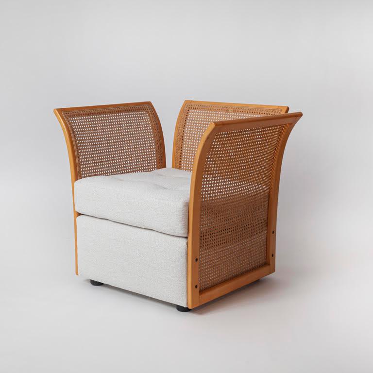 Suite of Rattan Furniture, Italy c. 1970, consisting of a Loveseat & Two Armchairs, the frames in flared poplar with woven rattan sides and upholstered seats
Armchairs: 29.5 x 33.5 x 29.5 in. (75 x 85 x 75 cm) each 
Loveseat: 29.5 x 55 x 29.5 in.