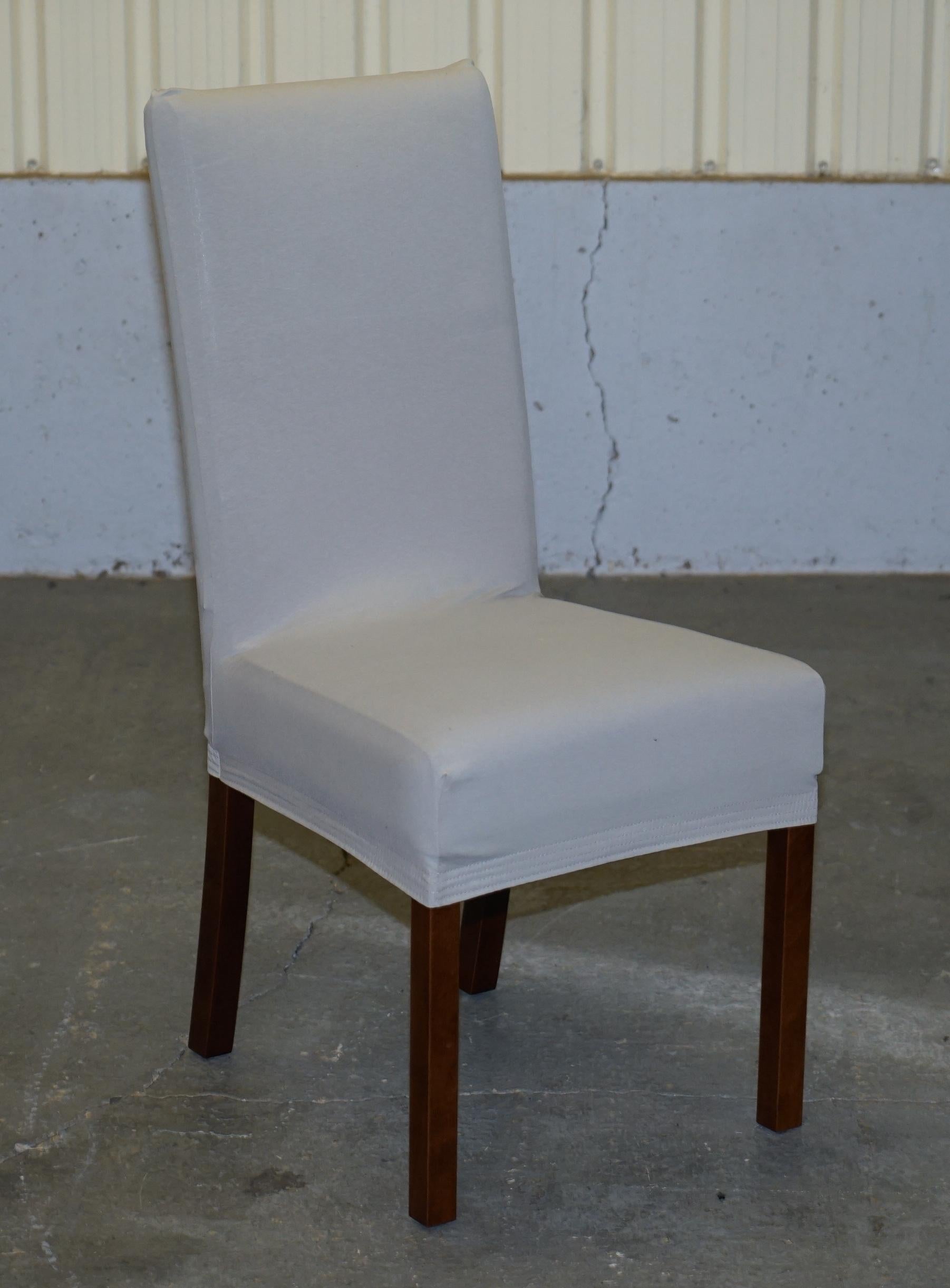 We are delighted to this suite of six bicast leather dining chairs with custom made fabric covers

These a good functional set of chairs, they are comfortable and very contemporary

They upholstery is bicast leather which has the backing of