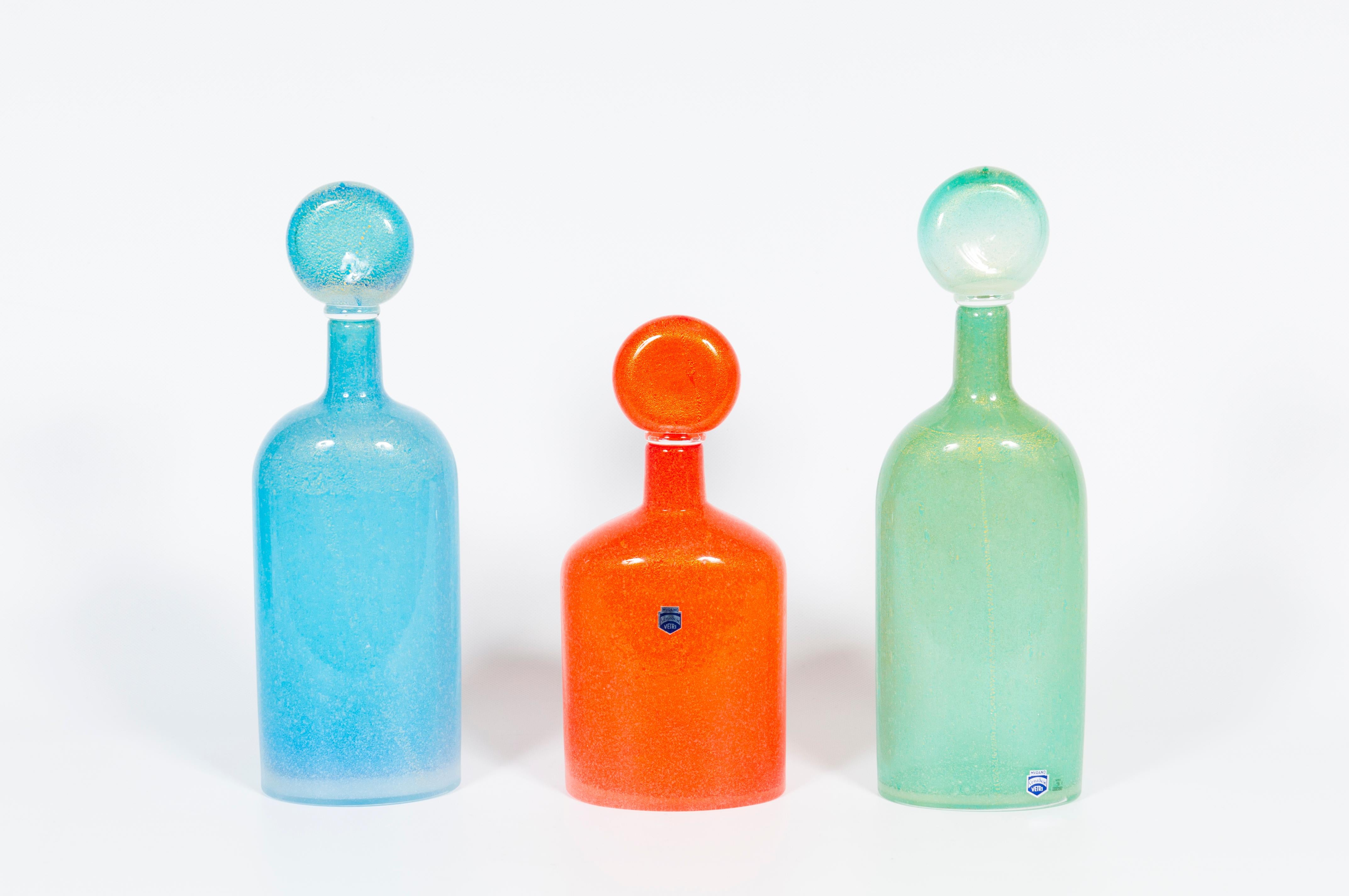 An unparalleled suite of three monumental glass bottles, each complete with its original, perfectly fitted stopper, masterfully hand-executed by the esteemed Cenedese Glassworks on Murano, Venice, circa 1970s.

This collection is a luxurious and