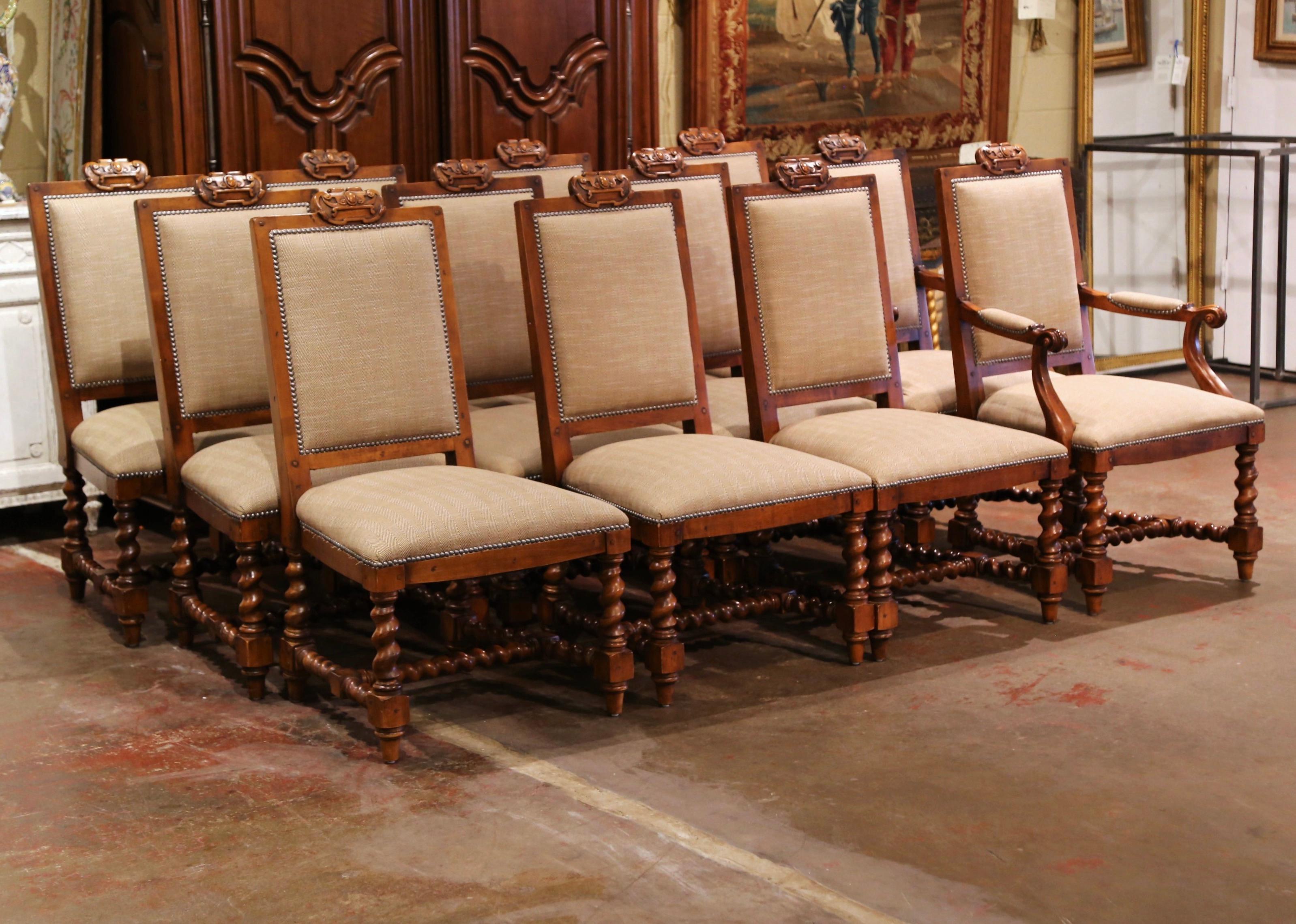 Dress a dining table with this elegant vintage set of 10 chairs and 2 matching armchairs. Crafted circa 1990 by Polo Ralph Lauren for Henredon Company, each large chair stands on barley twist legs ending with tapered feet, and embellished with a
