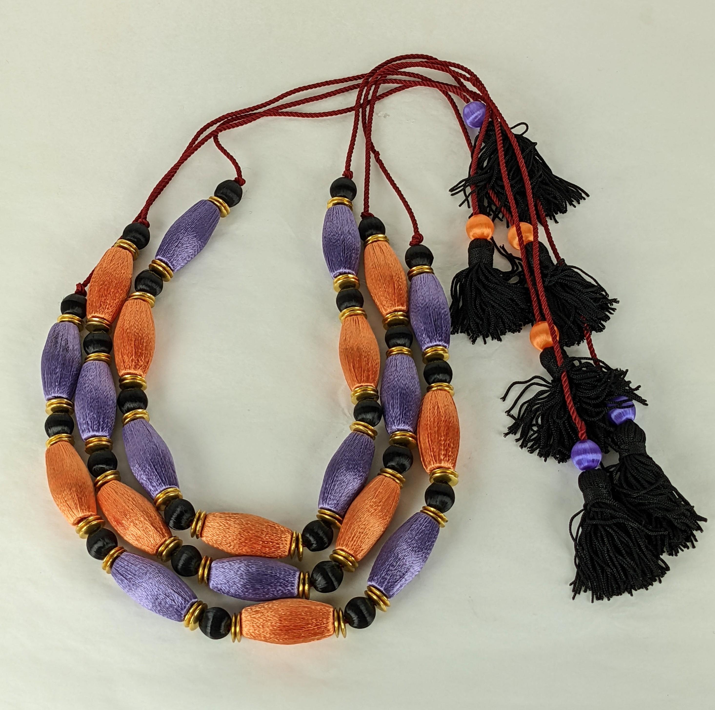 Amazing set of Yves Saint Laurent Haute Couture Passementerie necklaces of lilac and tangerine silk floss tube beads and gilt bronze saucer bead spacers.  Each Chinoiserie inspired necklace is strung on deep red cord with small black tassel ties.