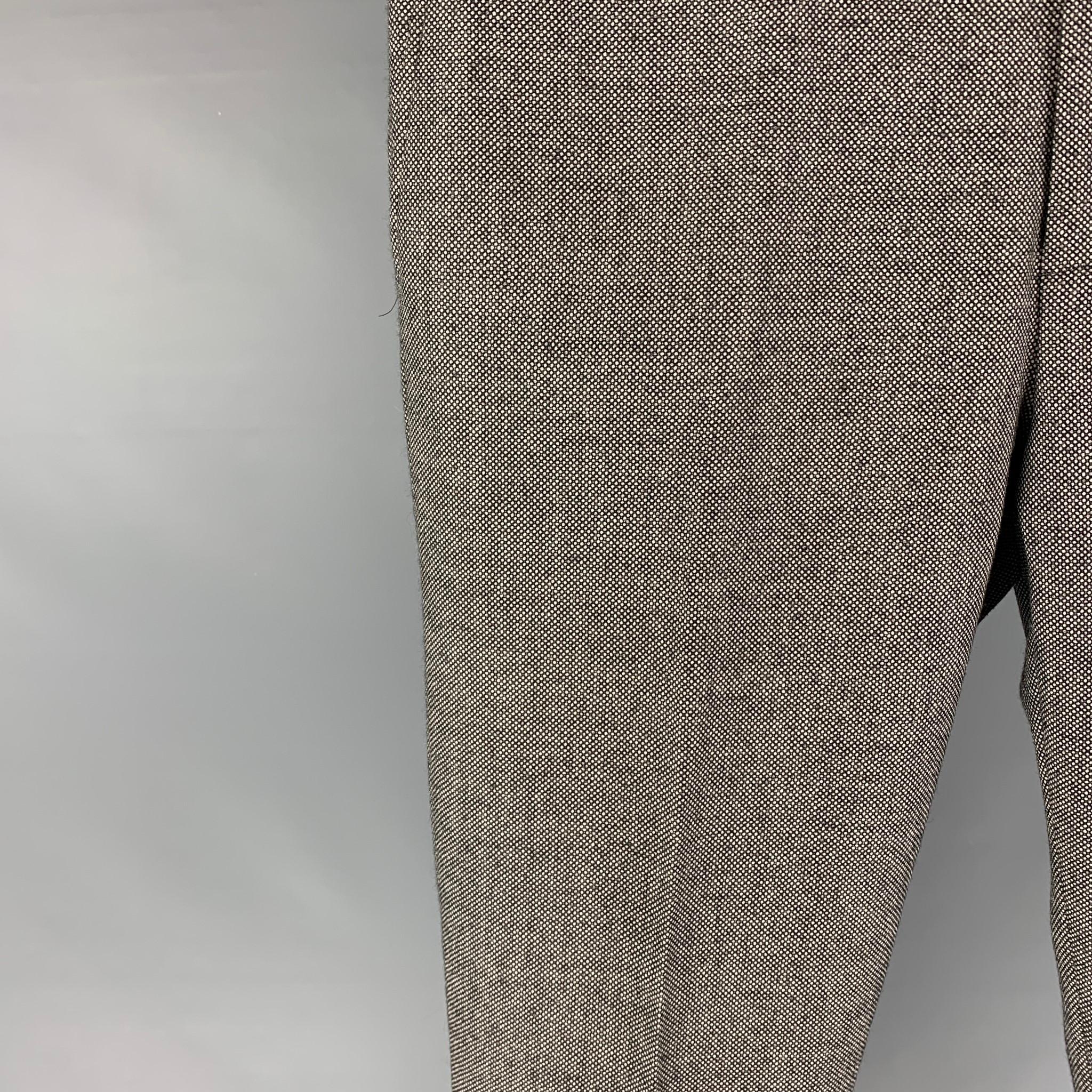 SUIT SUPPLY dress pants comes in a black & white nailhead wool featuring a flat front, slim fit, and a zip fly closure. 

Excellent Pre-Owned Condition.
Marked: 48/32

Measurements:

Waist: 34 in.
Rise: 10 in.
Inseam: 30 in.
Leg Opening: 13 in.

 