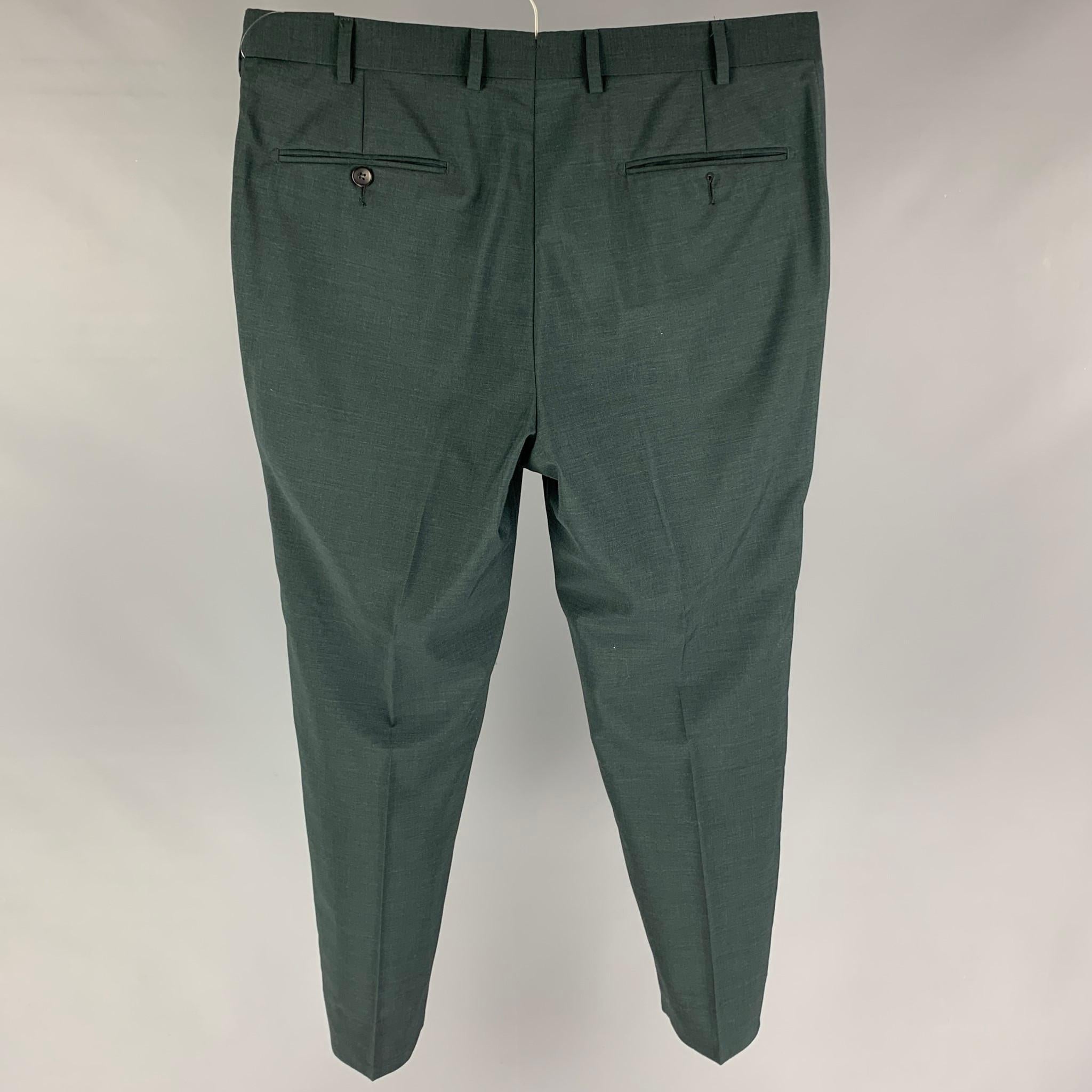 SUIT SUPPLY dress pants comes in a forest green wool featuring a flat front, slim fit, and a zip fly closure. 

Excellent Pre-Owned Condition.
Marked: 50

Measurements:

Waist: 34 in.
Rise: 10.5 in.
Inseam: 28 in.
Leg Opening: 13 in.

 